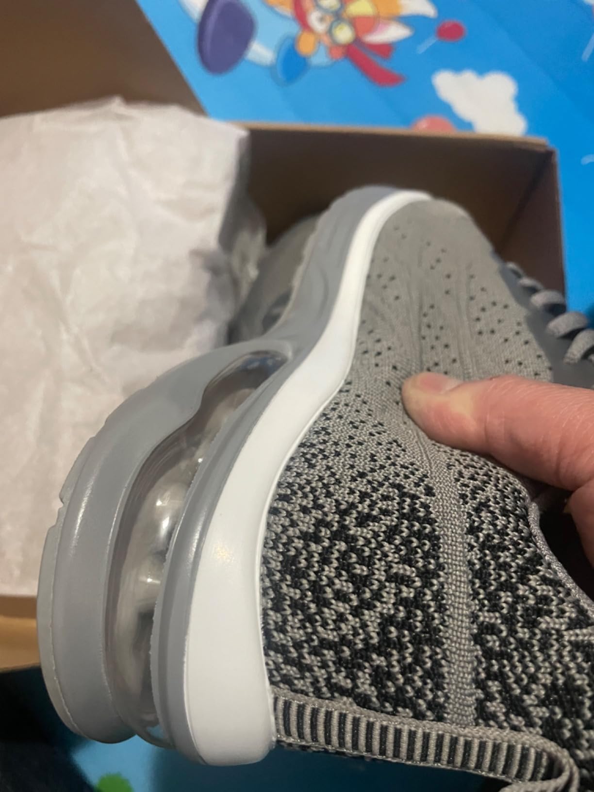 Close-up of QAUPPE shoe construction showing side profile and breathable knit material quality