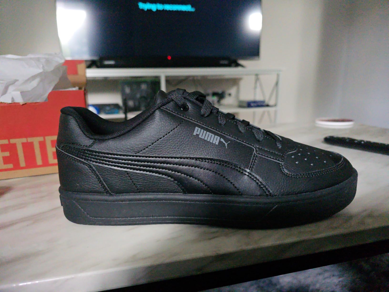 PUMA Caven 2.0 detail shot showing leather upper construction and iconic Formstrip design