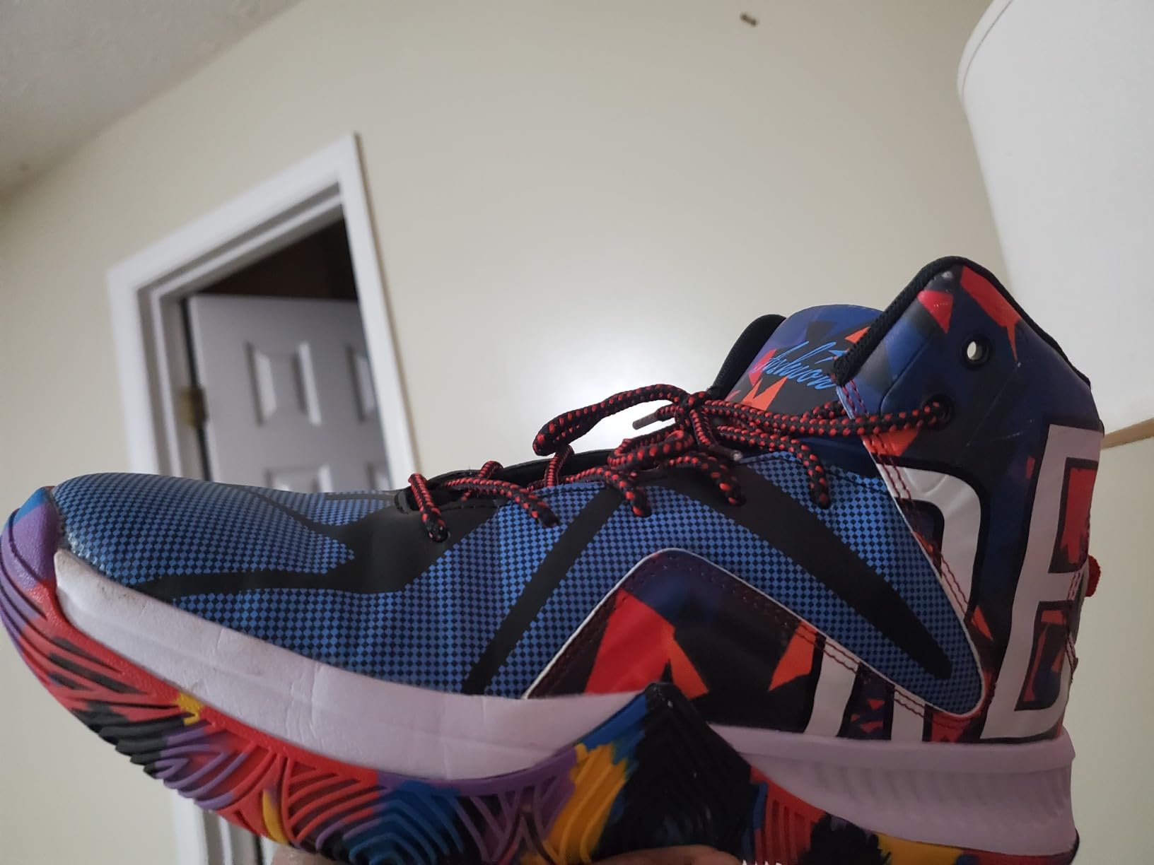 ASHION mens basketball shoes black silver colorway showing high-top design and multi-colored graphics