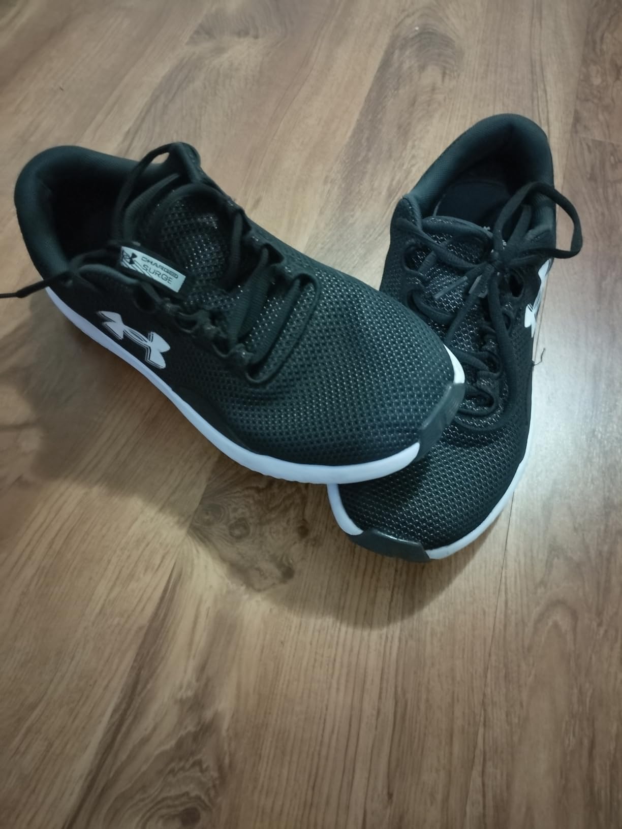 Under Armour Charged Surge 4 side profile showing Charged Cushioning midsole and rubber outsole design