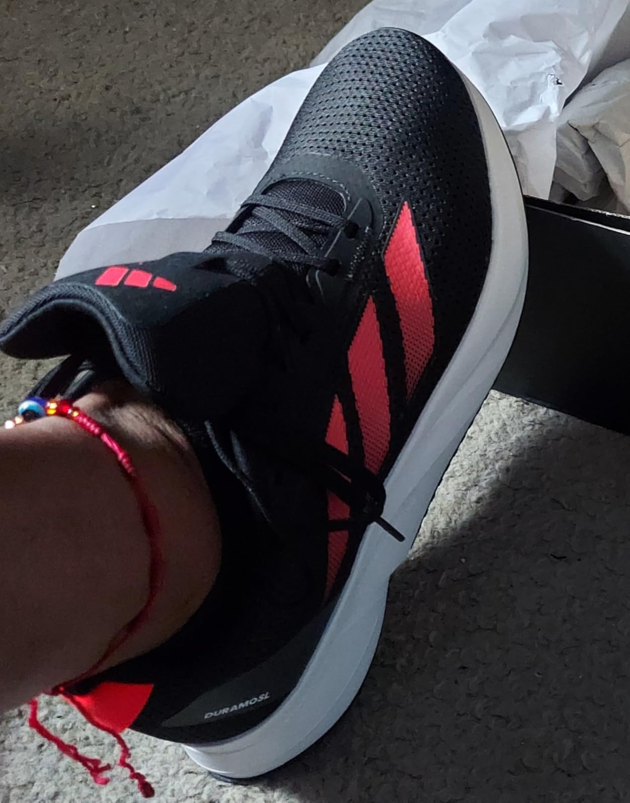 Adidas Duramo SL black running sneakers showing lightweight mesh upper and LIGHTMOTION cushioning