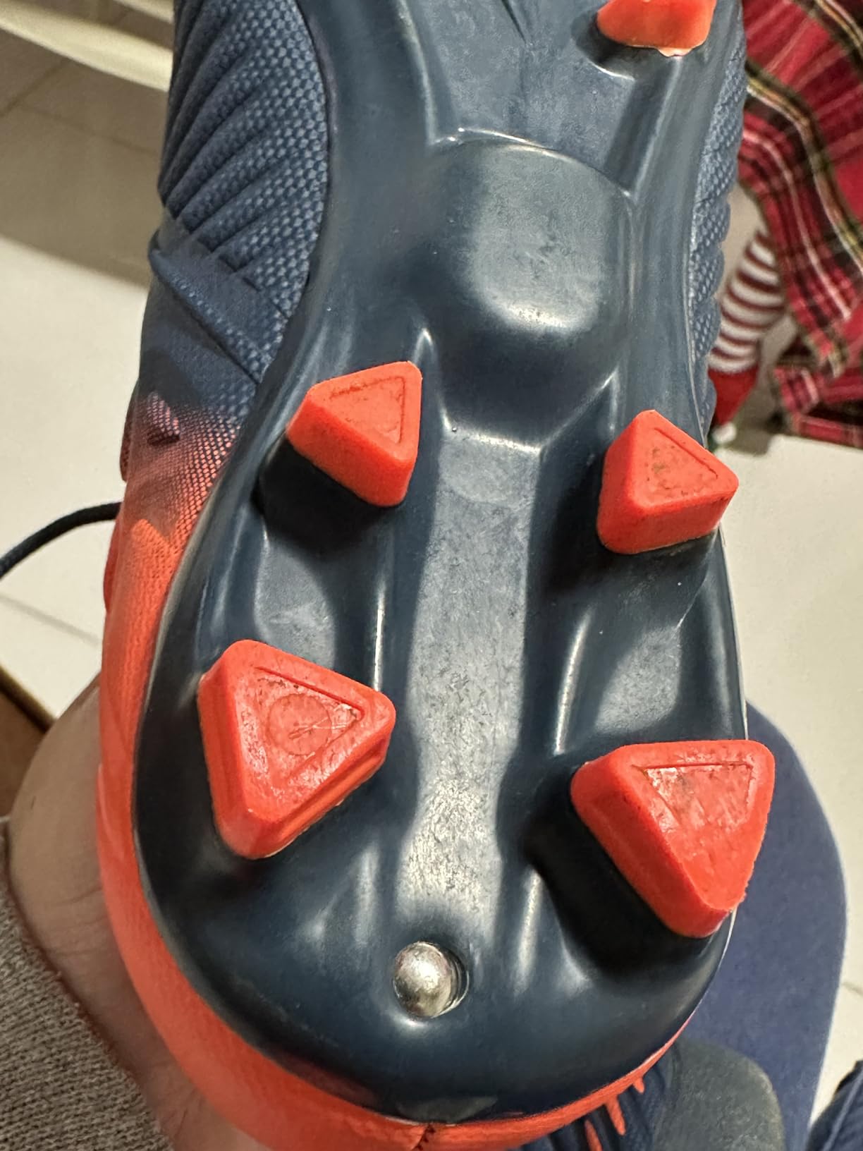 Bottom view of LEOCI soccer cleat sole showing AG/FG stud pattern for multi-surface traction