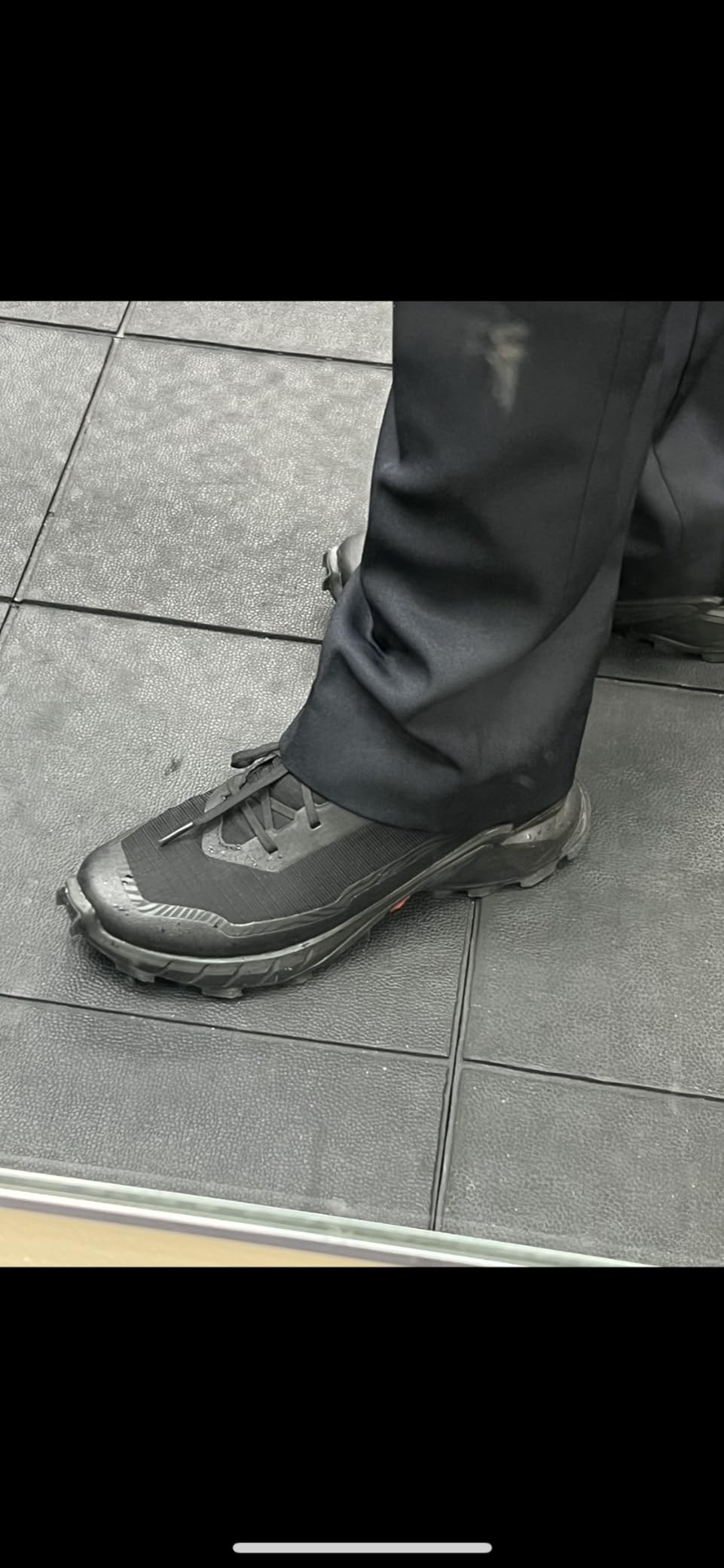 Salomon Alphacross 5 Gore-Tex being worn on muddy trail showing real-world performance