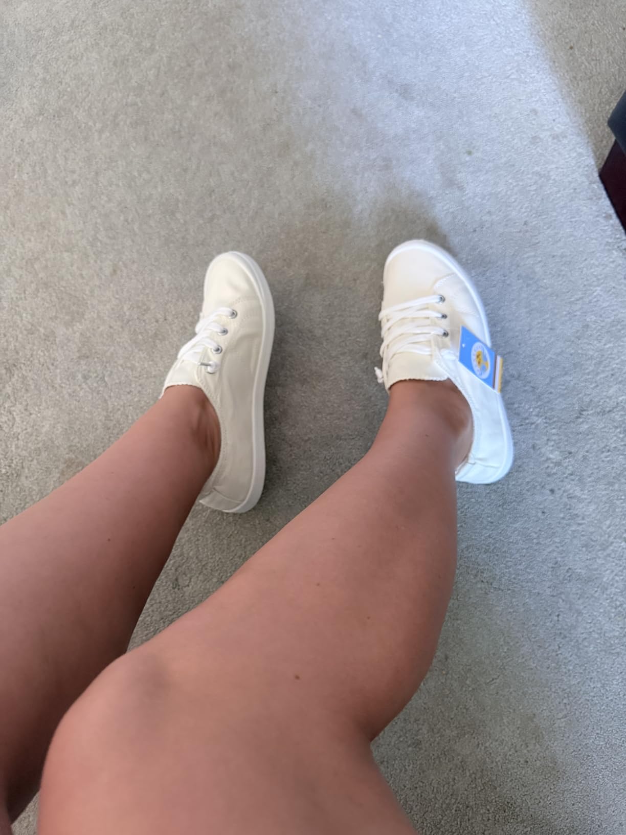 Women's slip on canvas sneakers in beige colorway showing classic low-top design