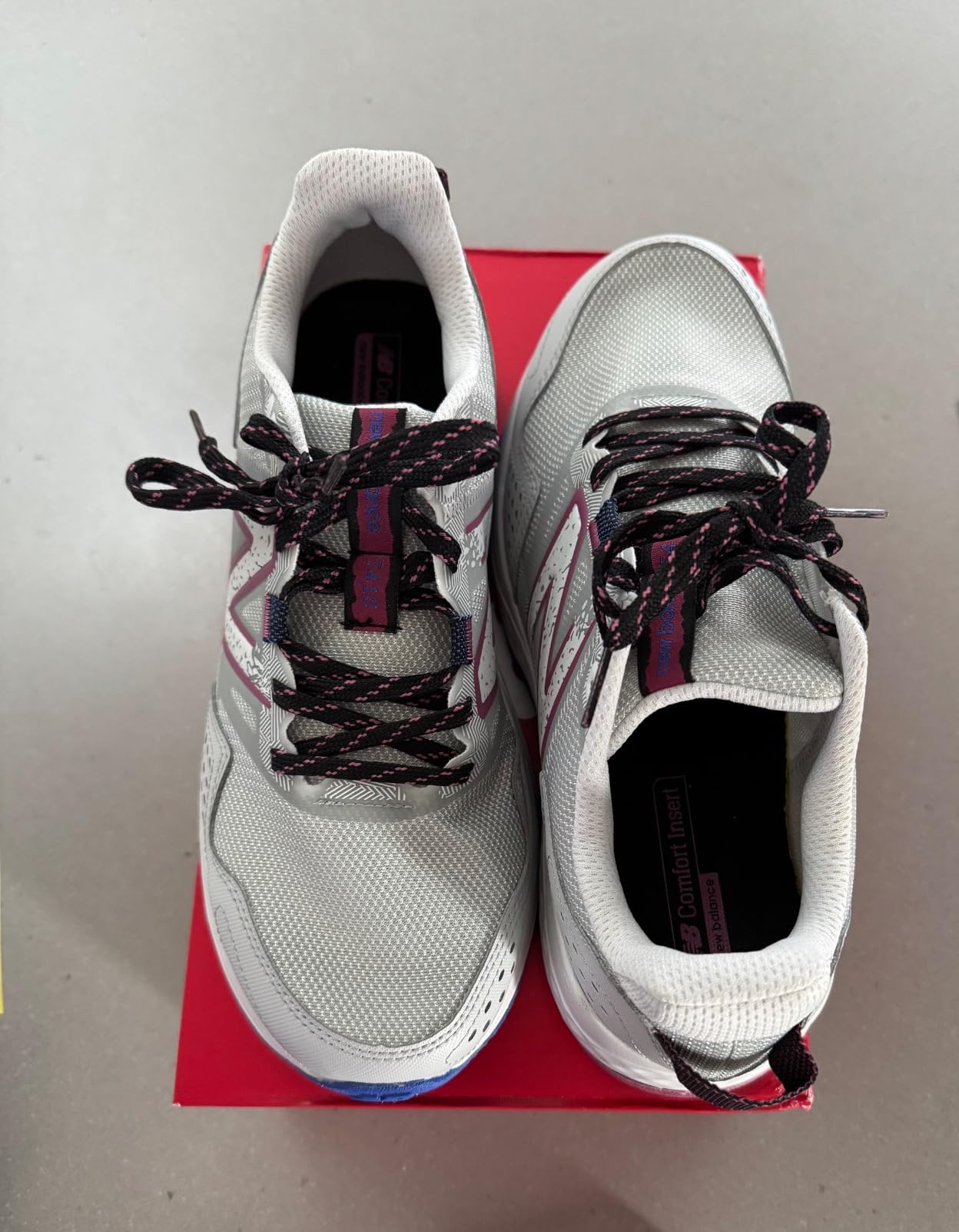 New Balance 410 V8 showing side profile with visible mesh panels and support overlays