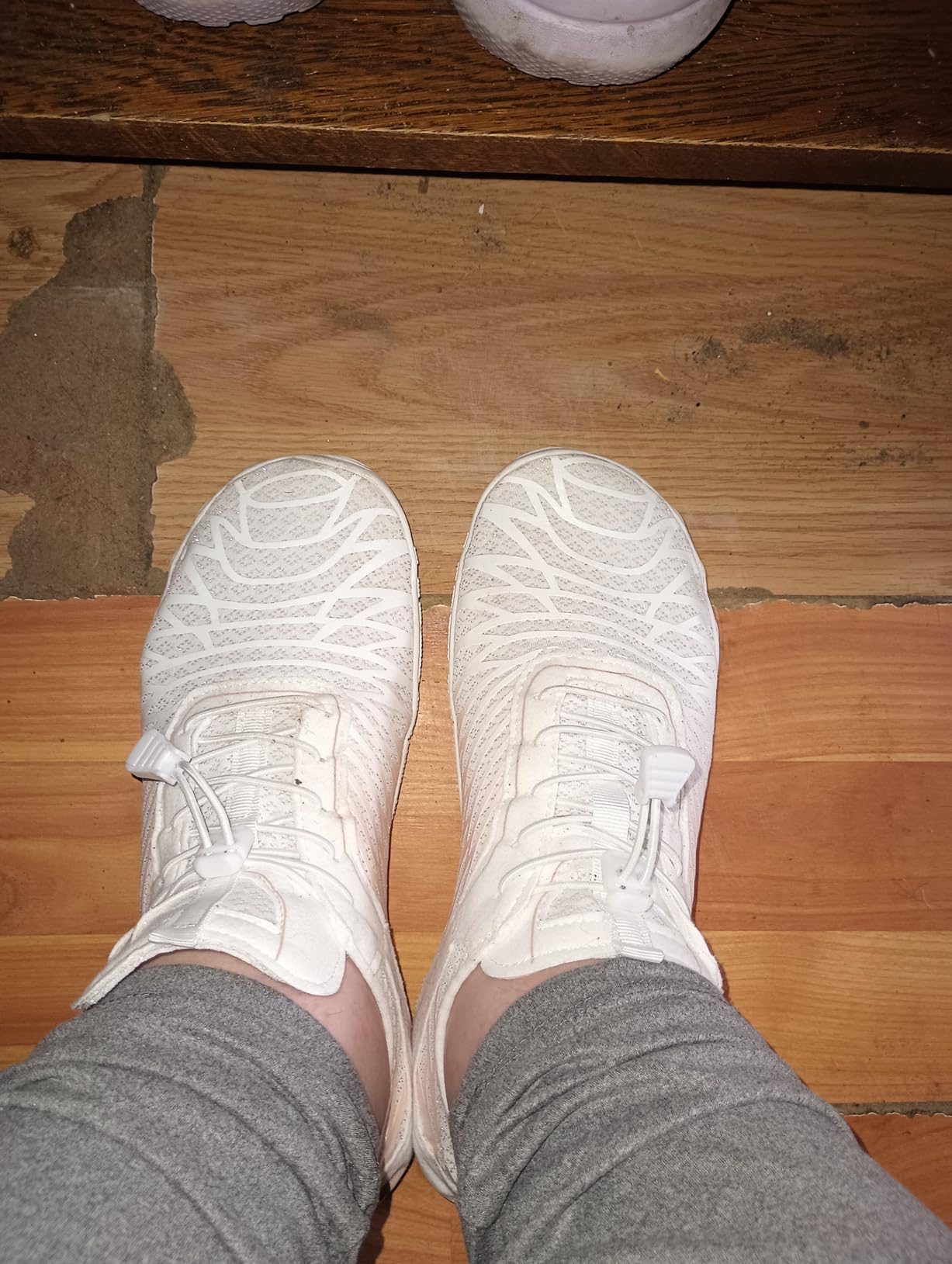 Side profile view showing minimal sole height and natural foot positioning in barefoot shoes