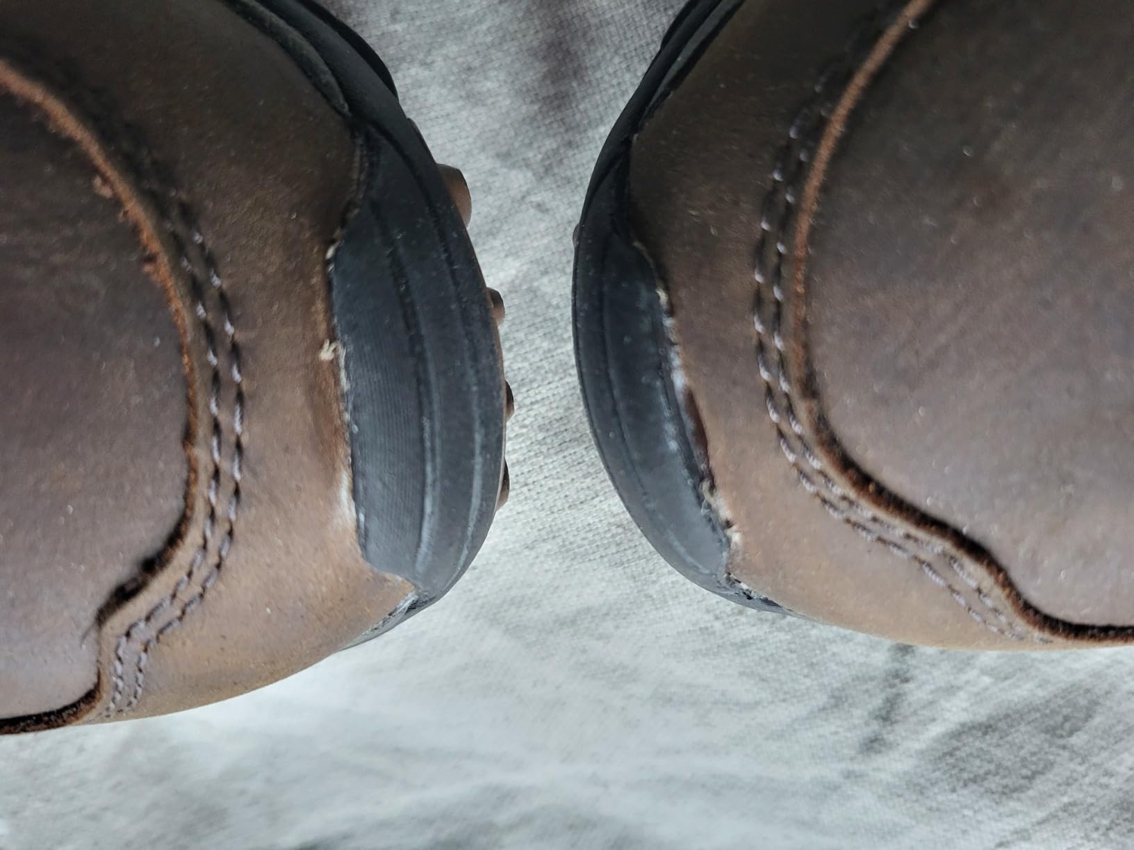 Manufacturing defects visible on Merrell Moab Adventure Lace showing quality control issues with glue and rubber edges