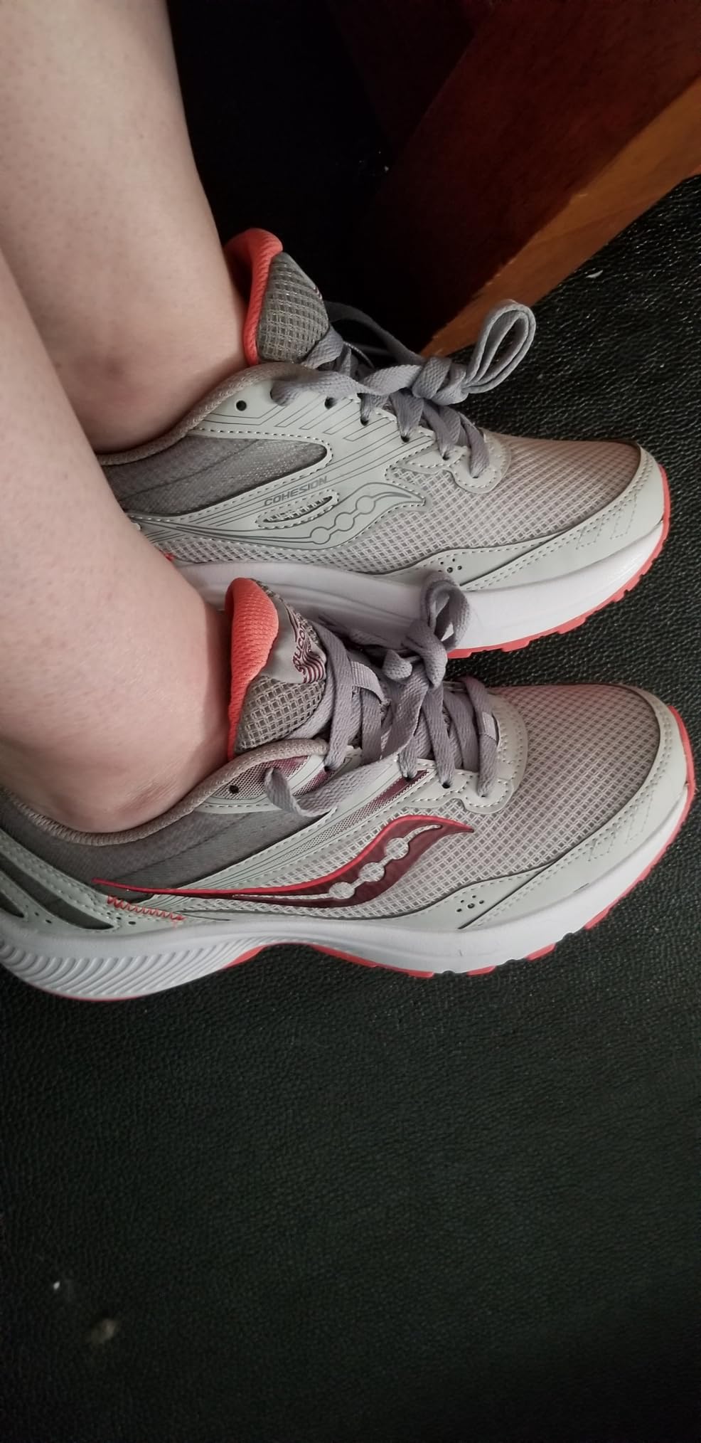 Saucony Cohesion 15 colorway showing orange accent details and overall design aesthetic