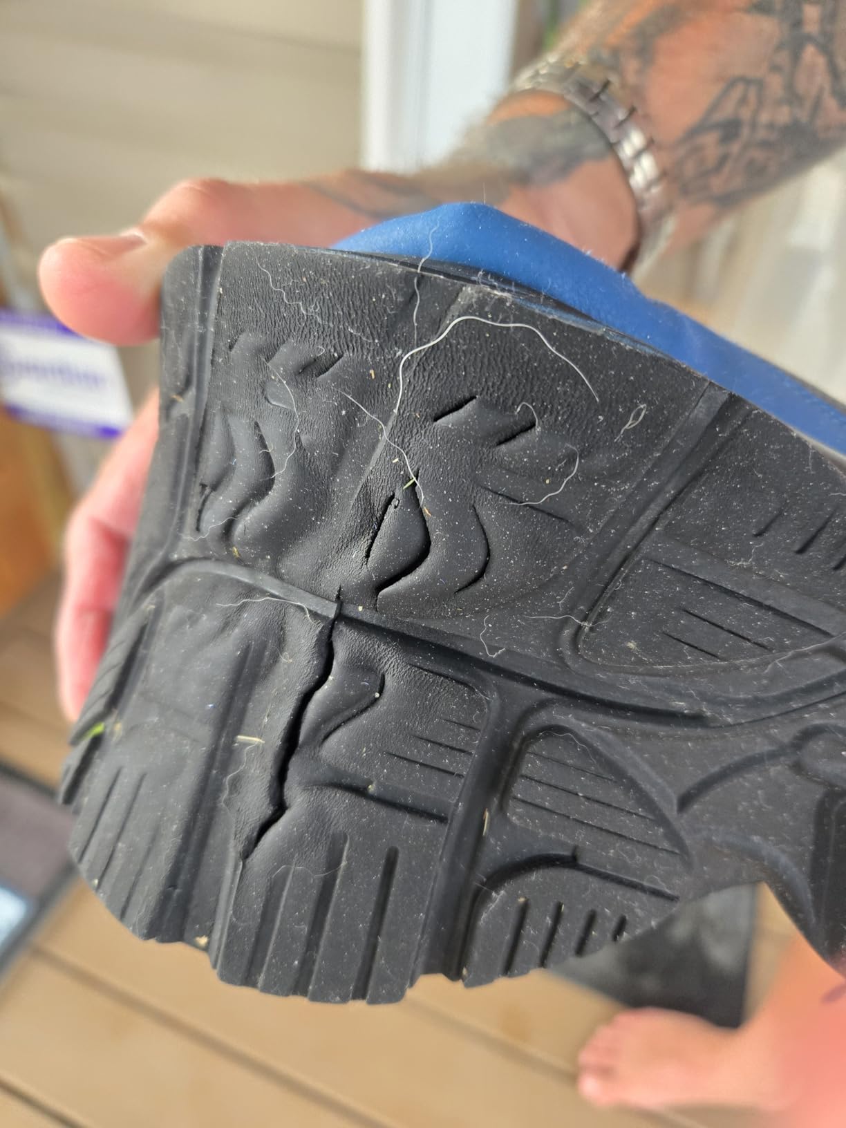 Close-up of Joomra sneaker sole showing wear pattern and durability concerns after extended use