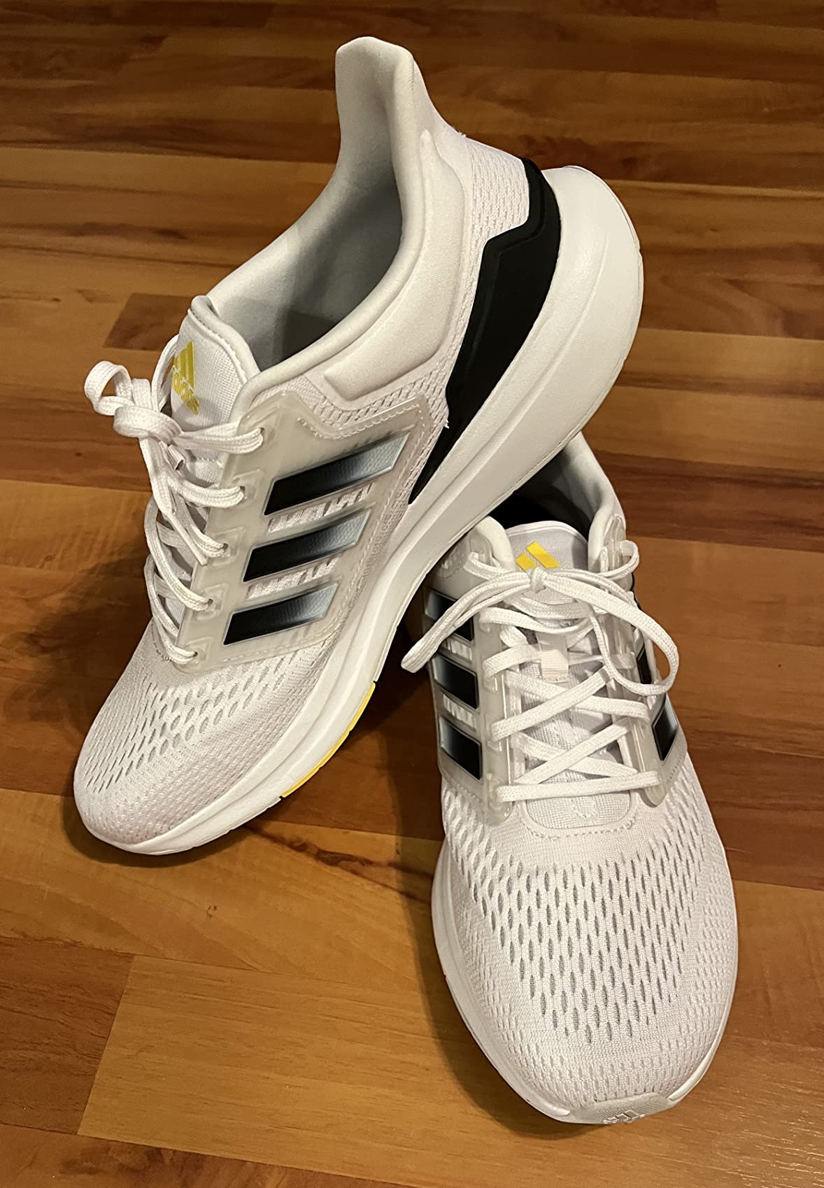 Marketing comparison showing adidas Eq21 features versus actual performance results