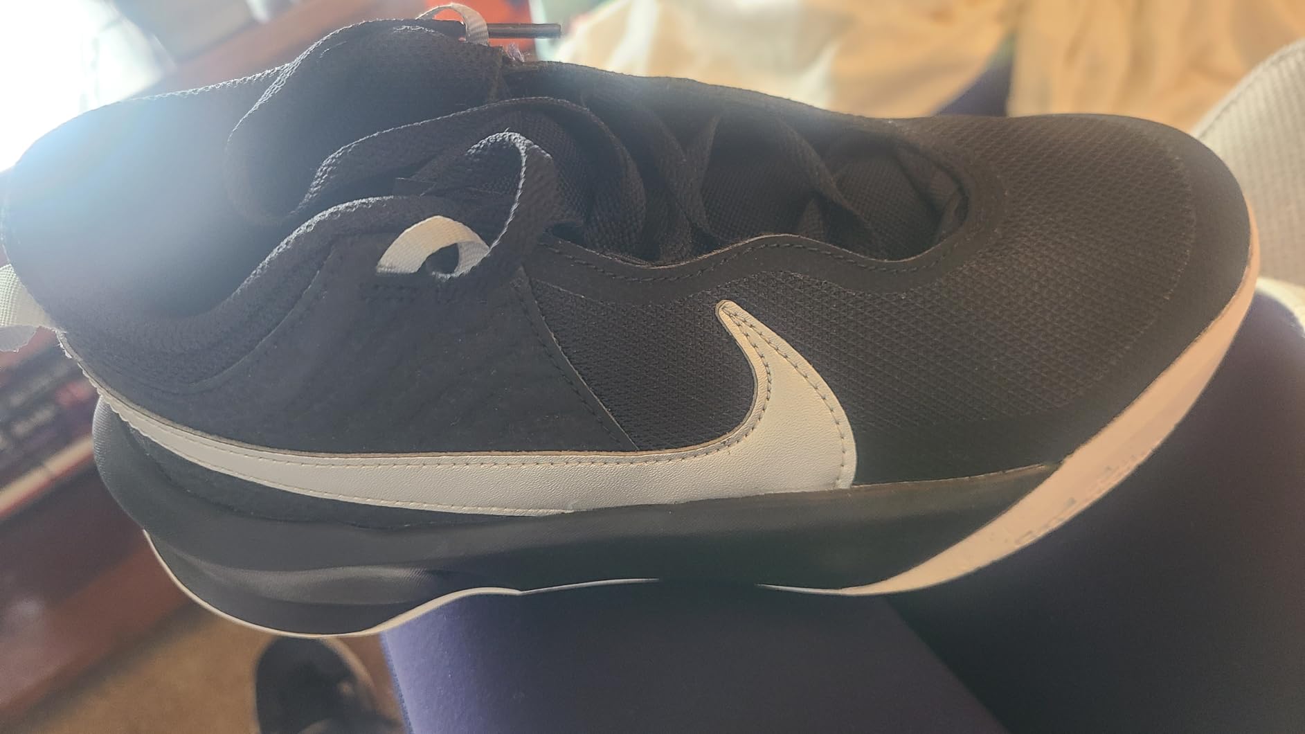Nike Team Hustle D 10 side profile showing ankle collar and sole pattern design