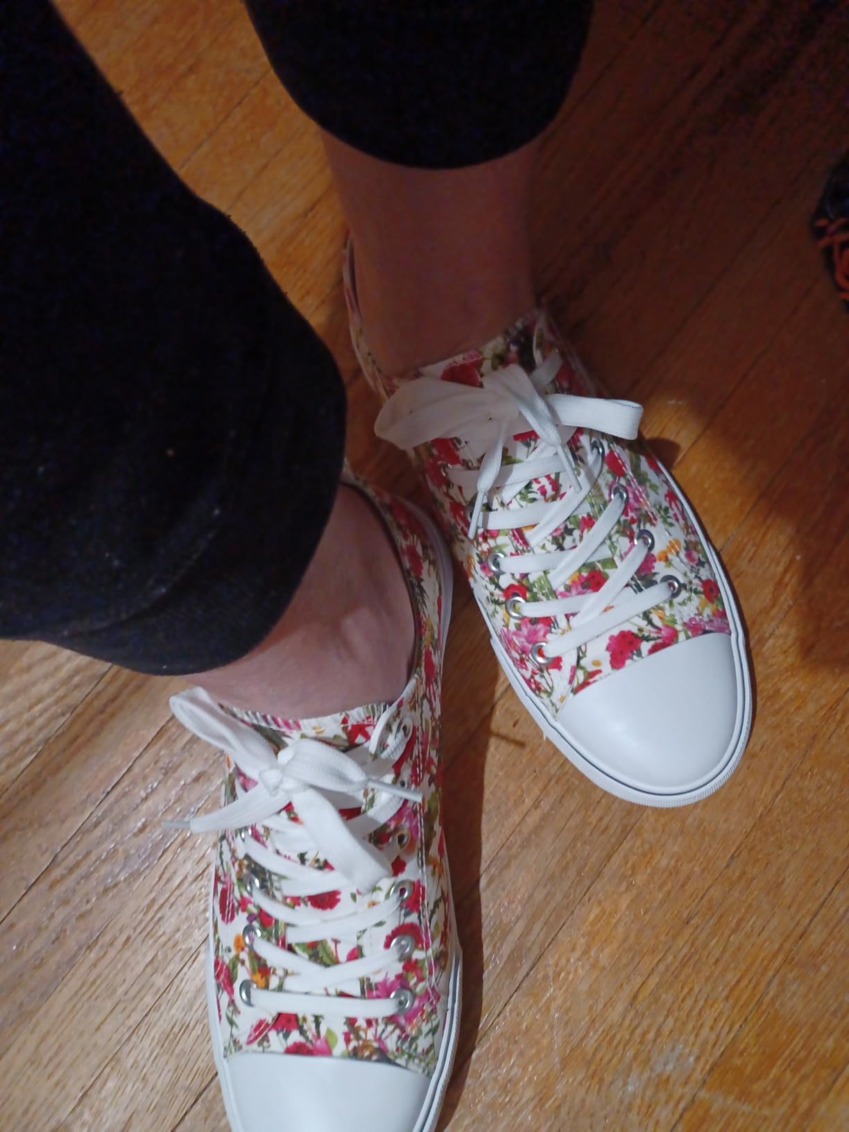 Close-up detail of Adokoo canvas sneakers showing floral print pattern and canvas construction