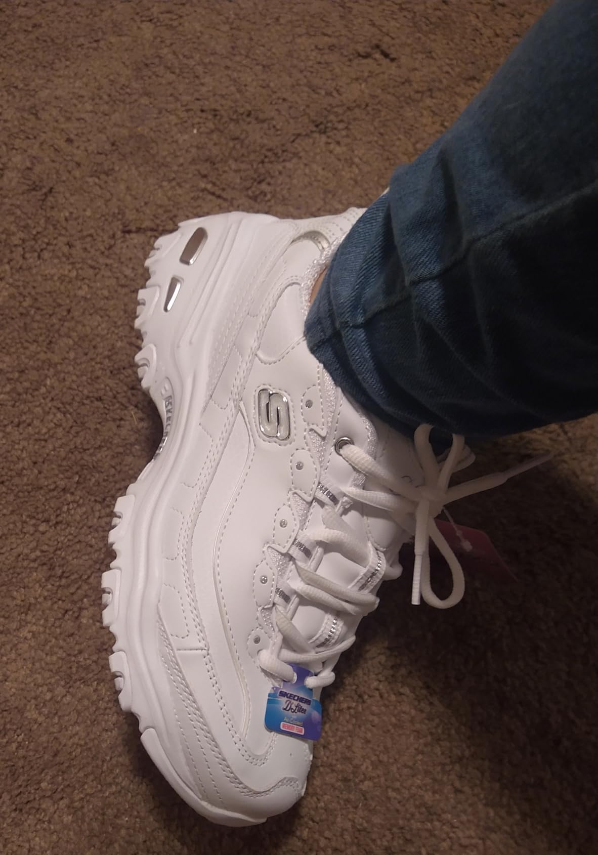Skechers D'Lites worn outdoors showing practical white sneaker styling
