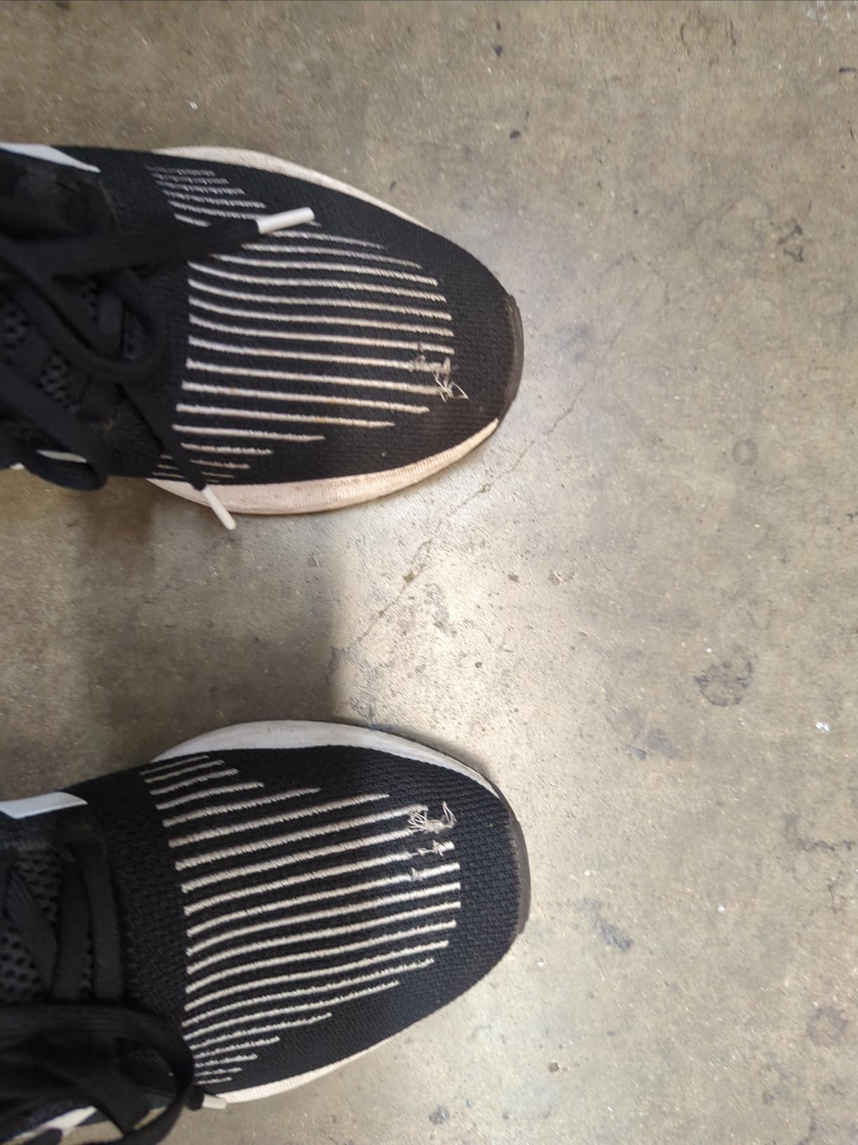 Adidas Swift Run sneaker showing failed lace eyelet that has pulled out from the upper