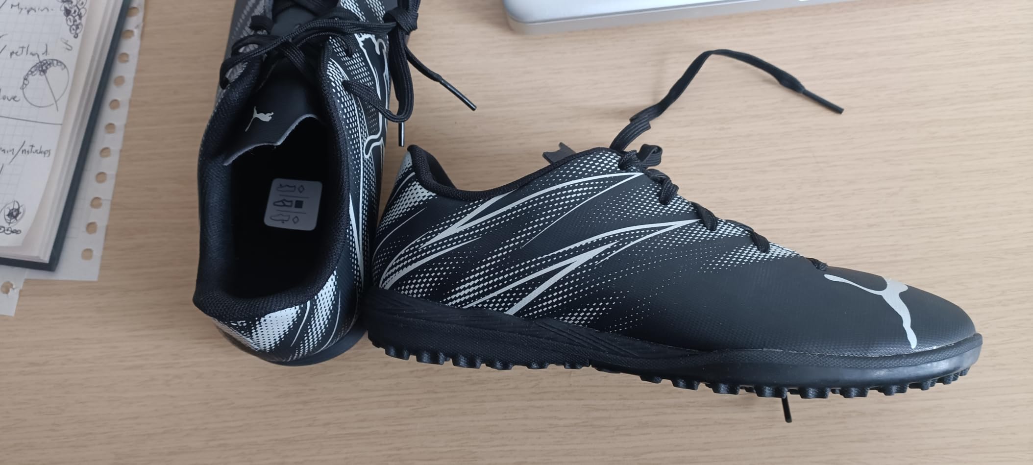 Side view of PUMA Attacanto showing sleek profile and lace-up design for secure fit