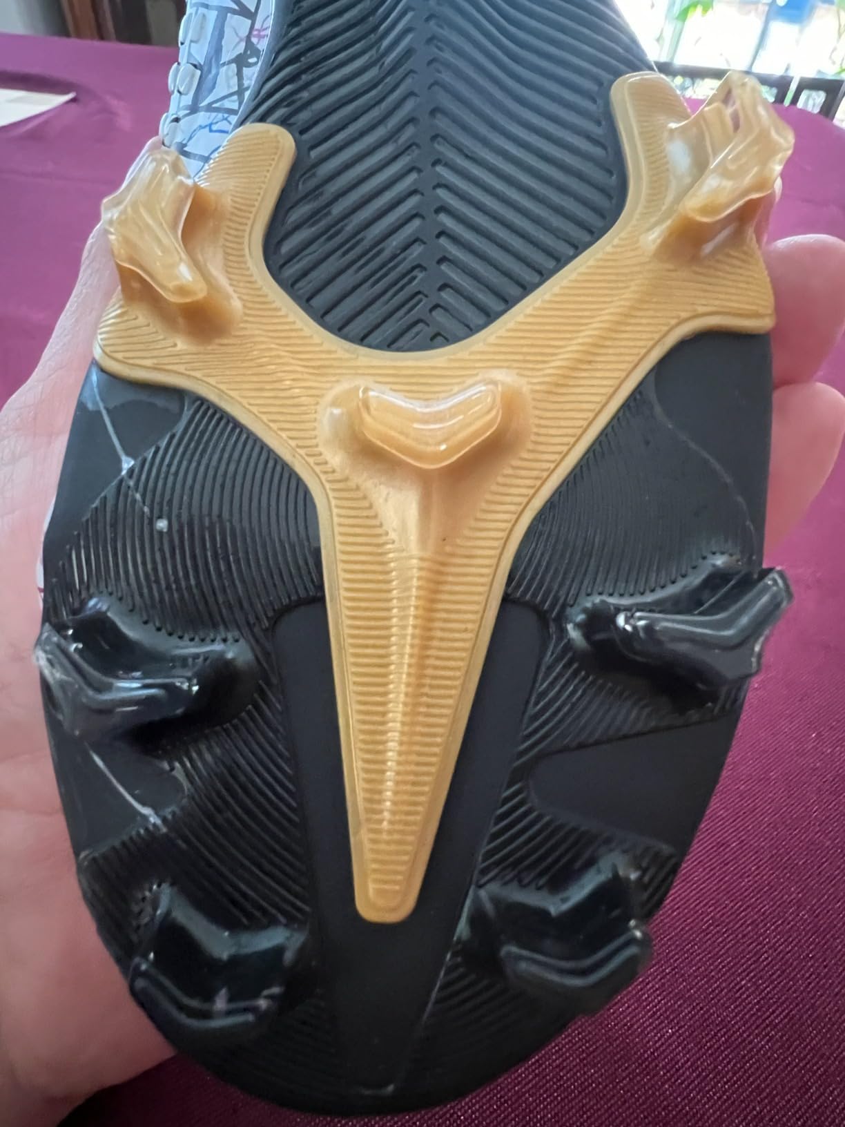 Soccer cleats detail showing high ankle collar and lace system design