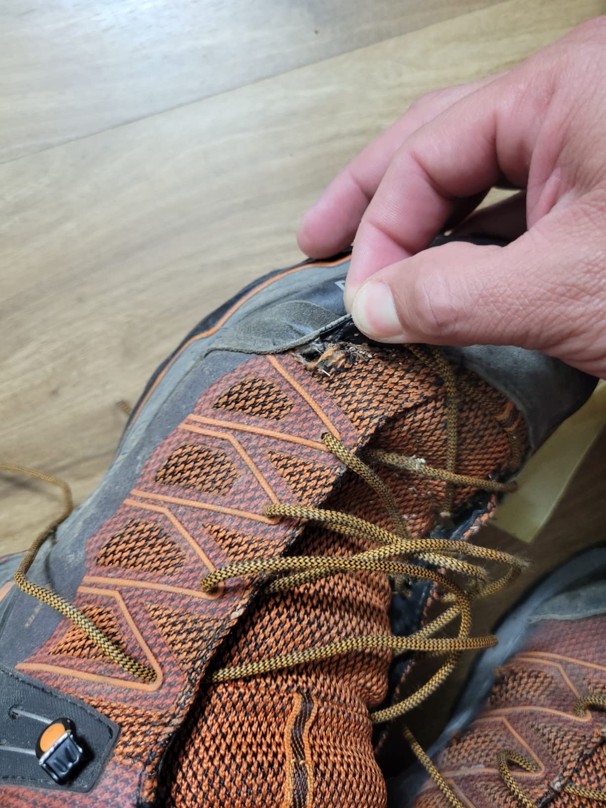 Hiking boots showing ripped material and durability issues after three months use