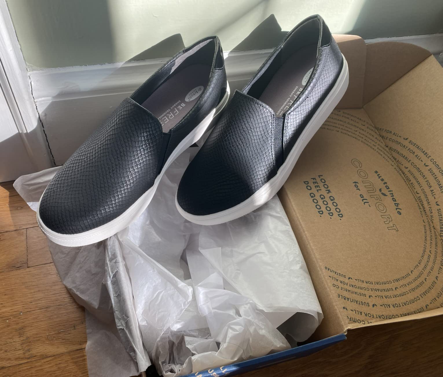 Dr. Scholl's Women's Nova slip-on sneakers in black showing sleek profile and platform sole design