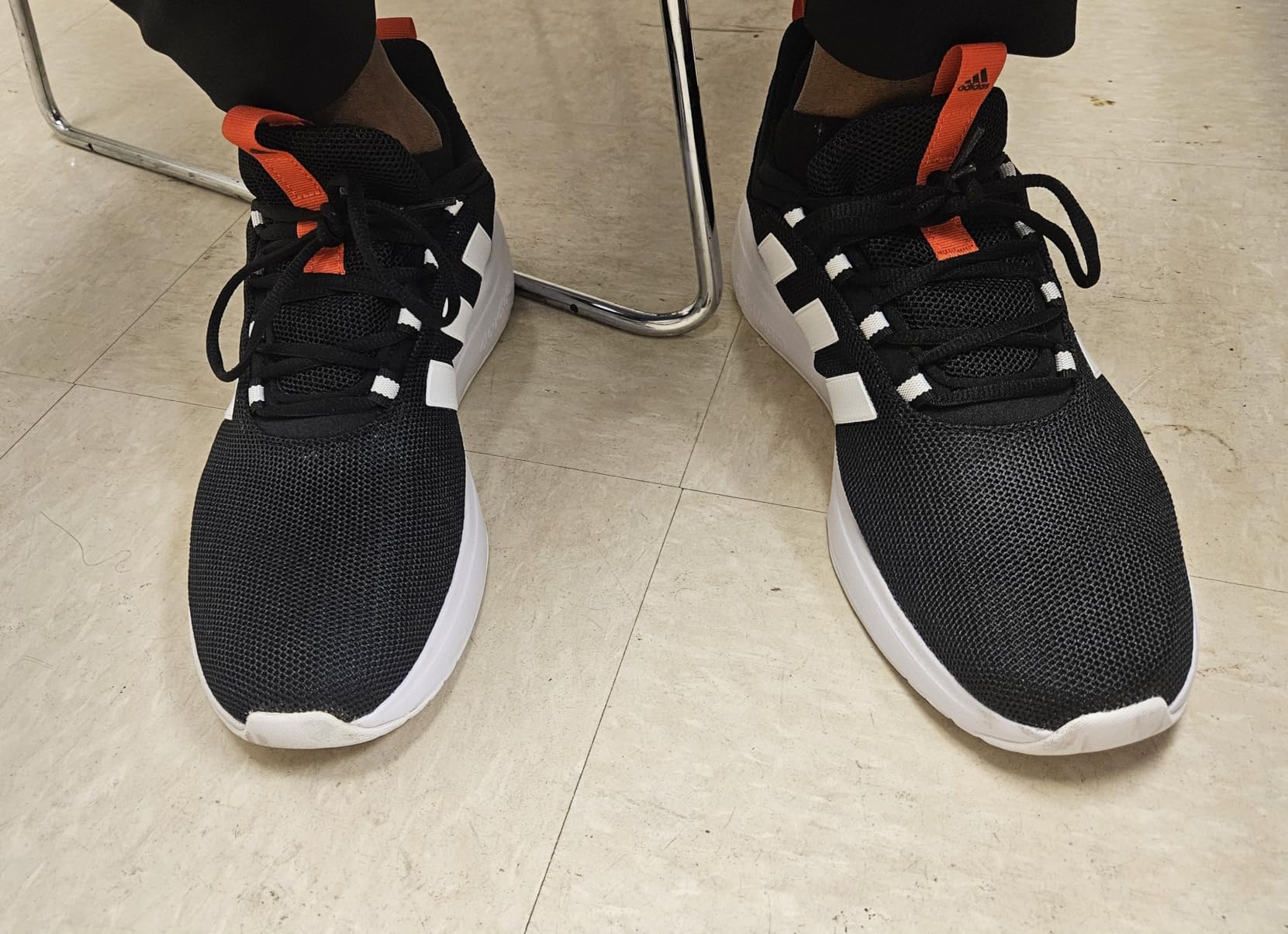 Close-up view of Adidas Racer TR23 mesh upper construction showing breathable material and three stripes design
