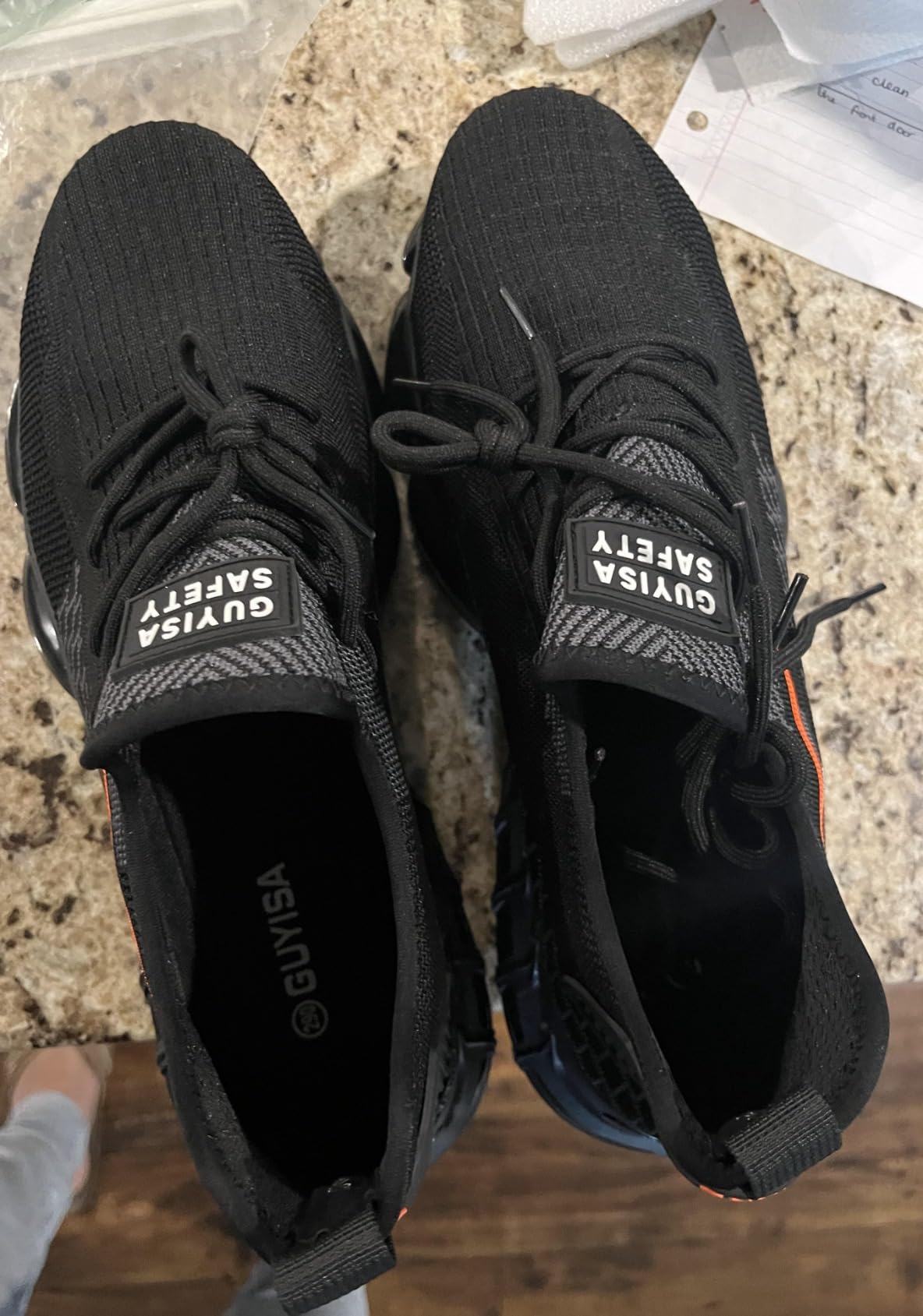 Steel toe shoes demonstrating puncture resistant sole and grip pattern for construction work