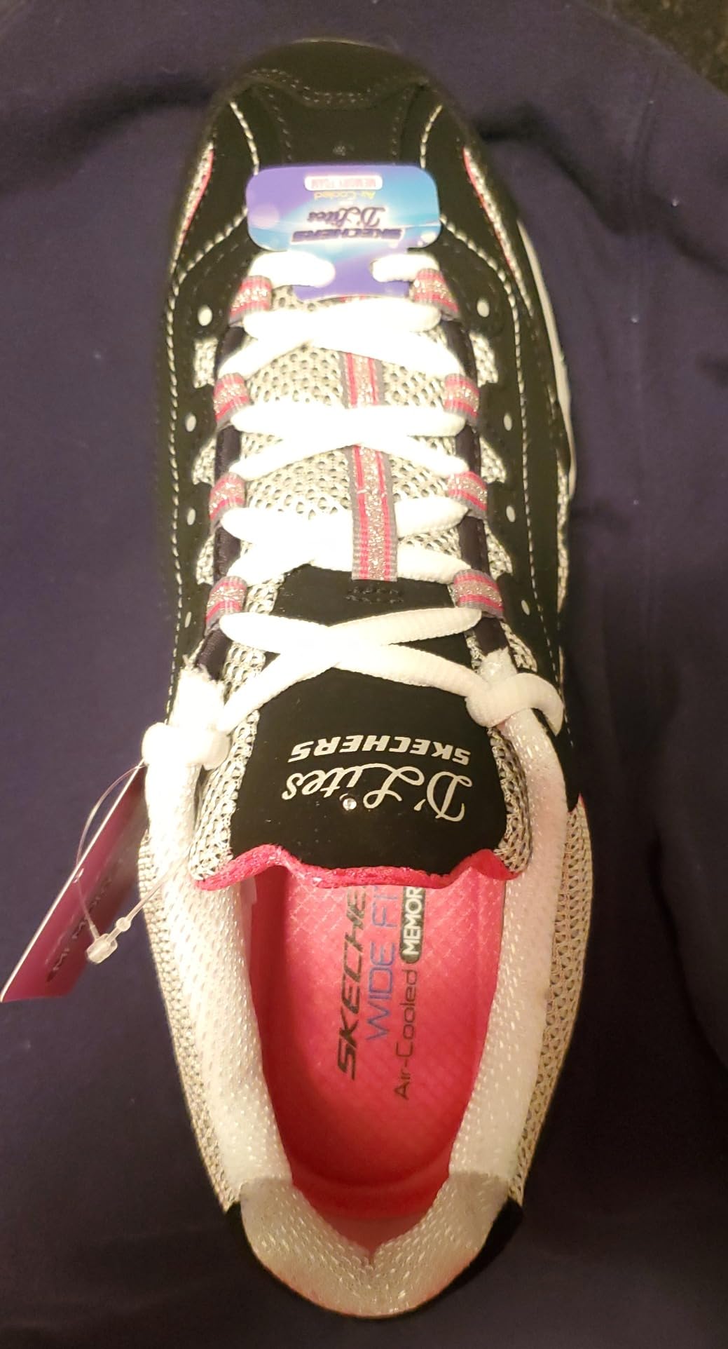 A detailed side view of the Skechers D'Lites sneaker showing the layered leather and synthetic upper.
