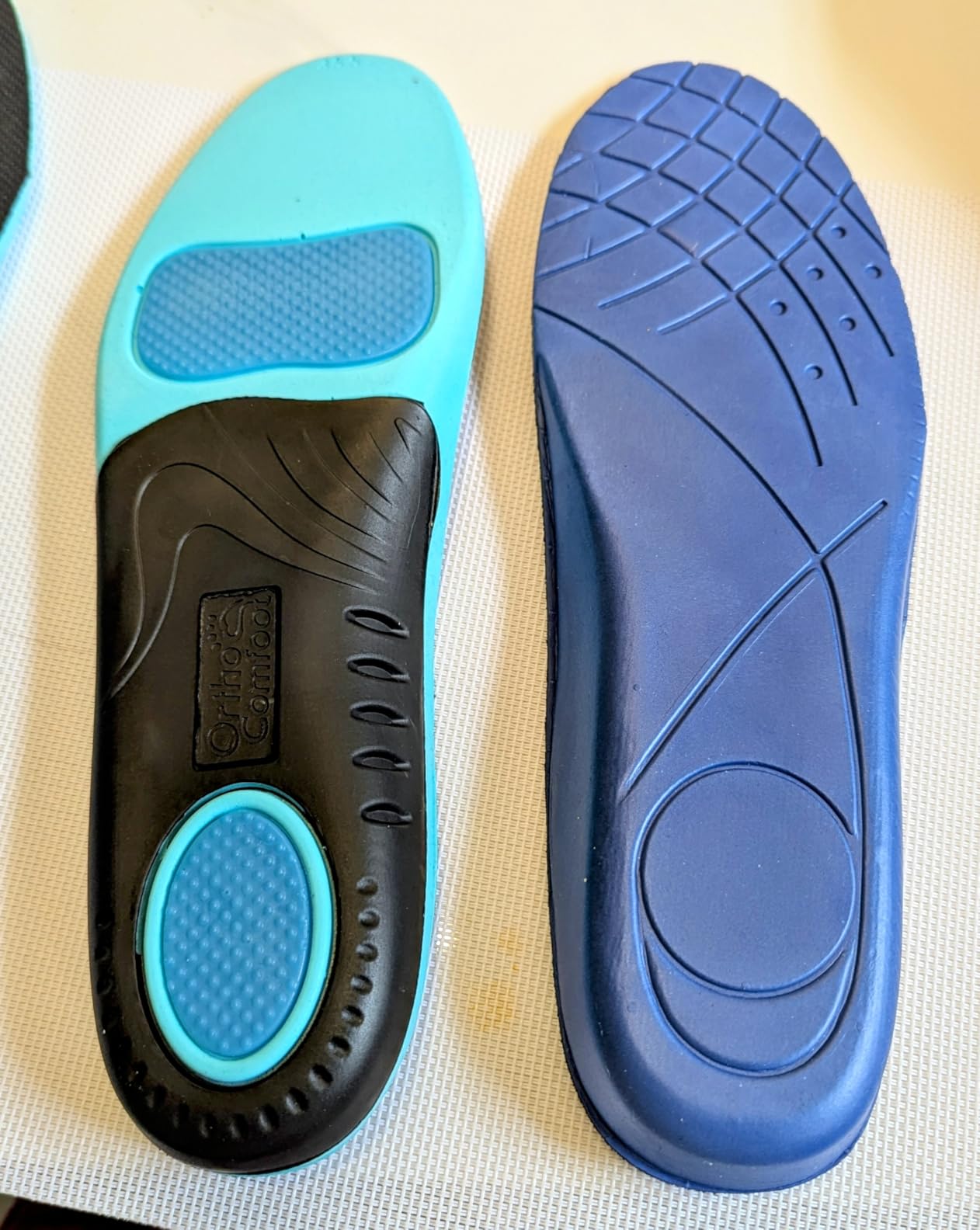 OrthoComfoot orthopedic insoles showing arch support design with gel cushioning and TPU base