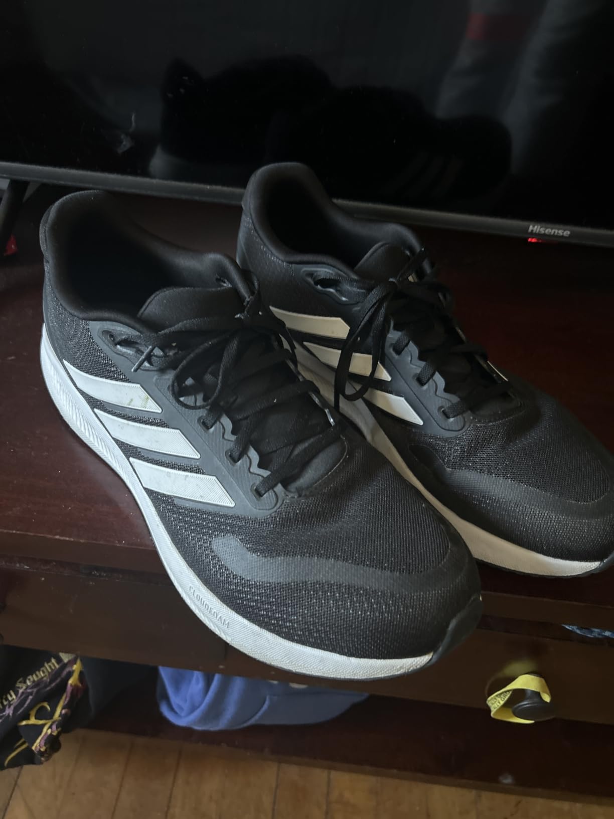 Adidas Men's Run Falcon 5 sneaker showing black colorway with three stripes design