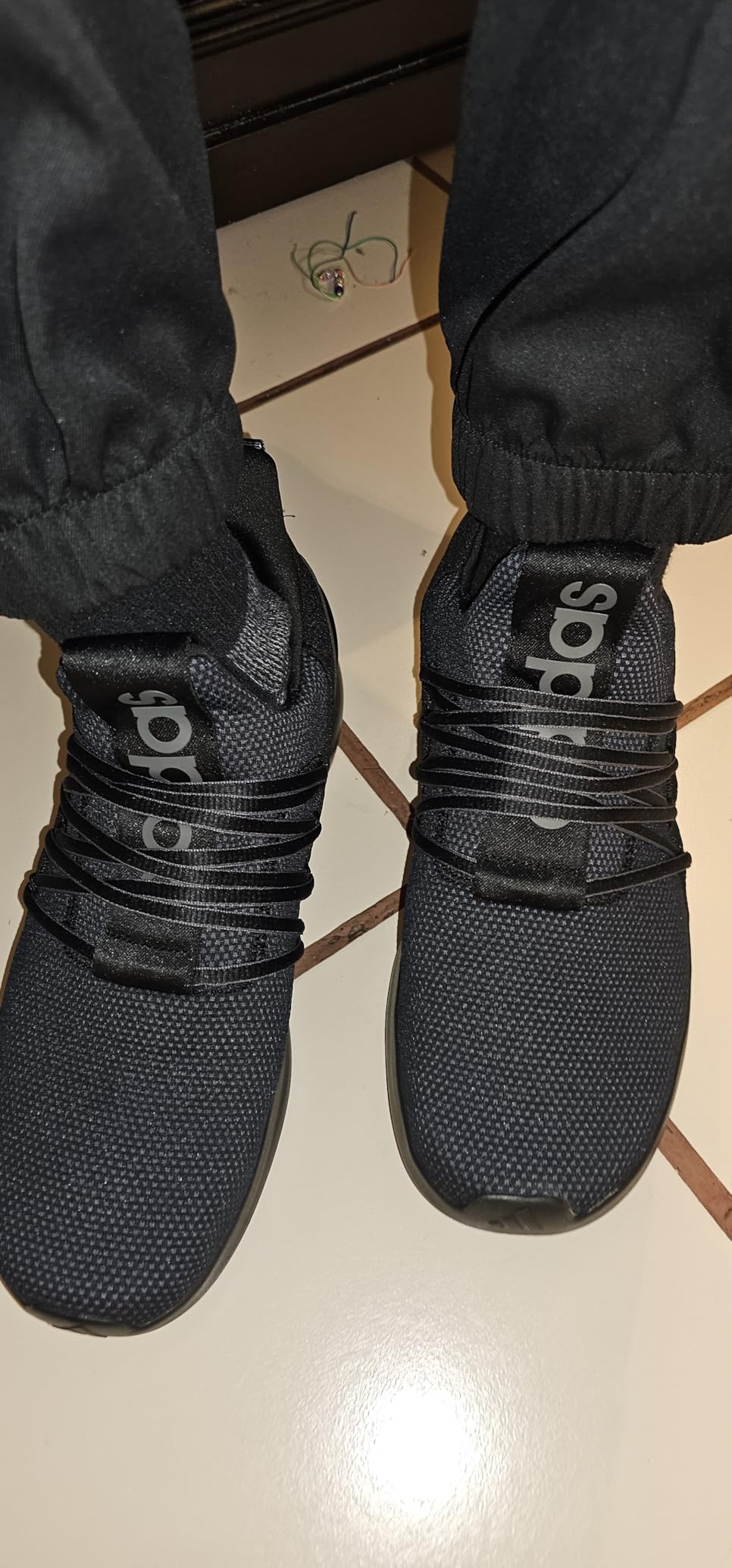 Bottom view of Adidas Lite Racer Adapt 7.0 showing rubber outsole pattern and wear after testing