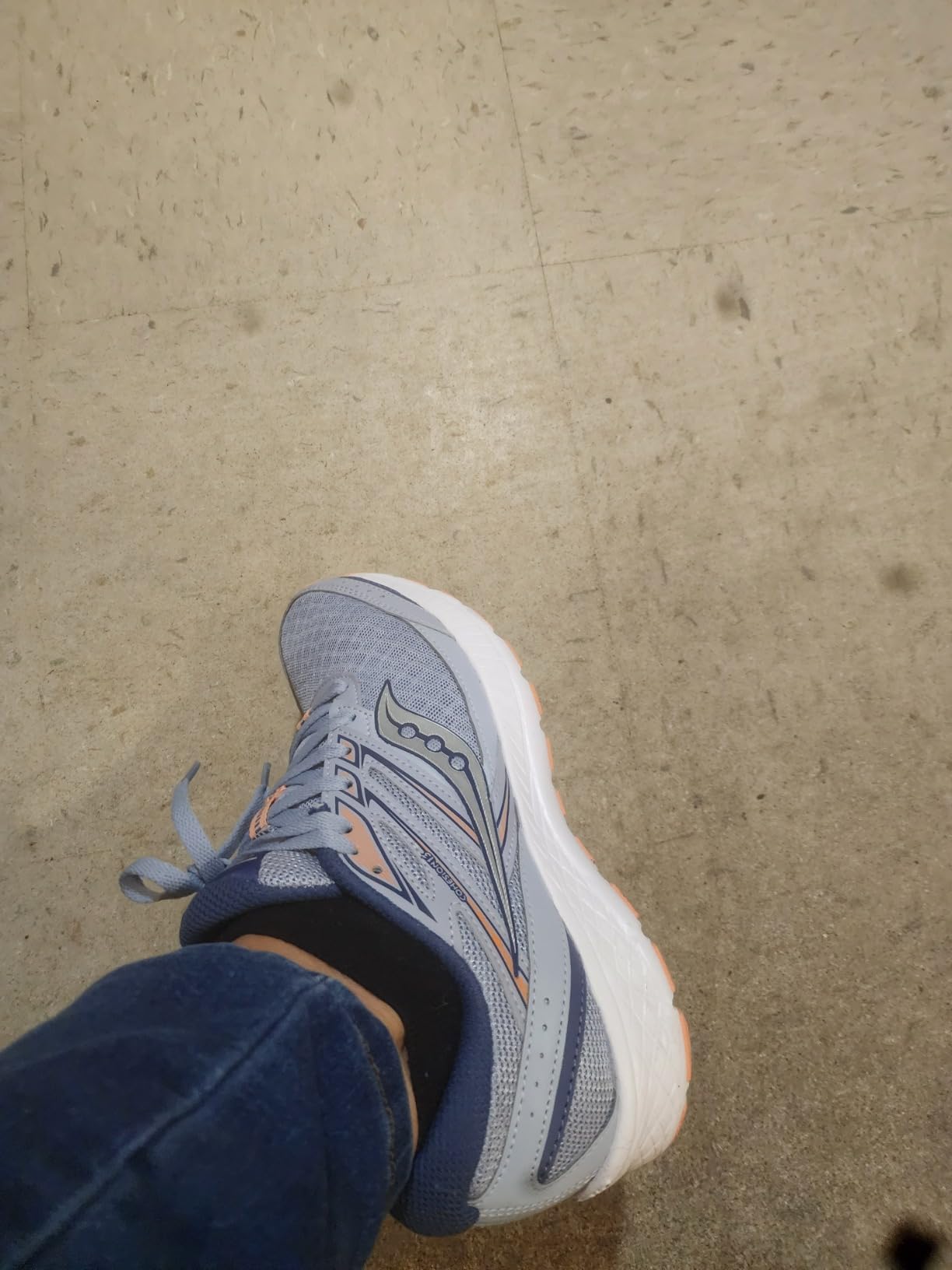 Multiple Saucony Cohesion 13 shoes showing different colorway options available for women including navy, gray, and pink combinations