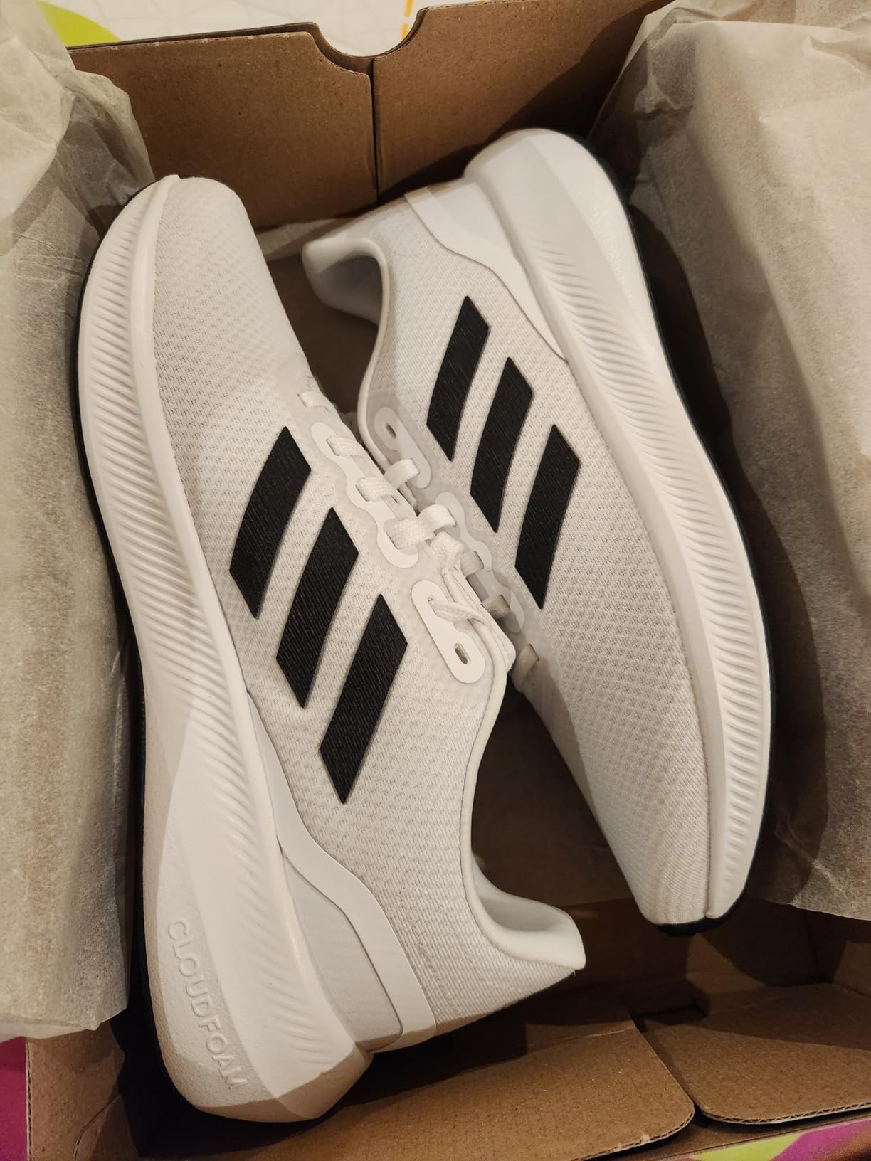 Product packaging and presentation of Adidas Run Falcon 3.0 showing brand promise and marketing claims