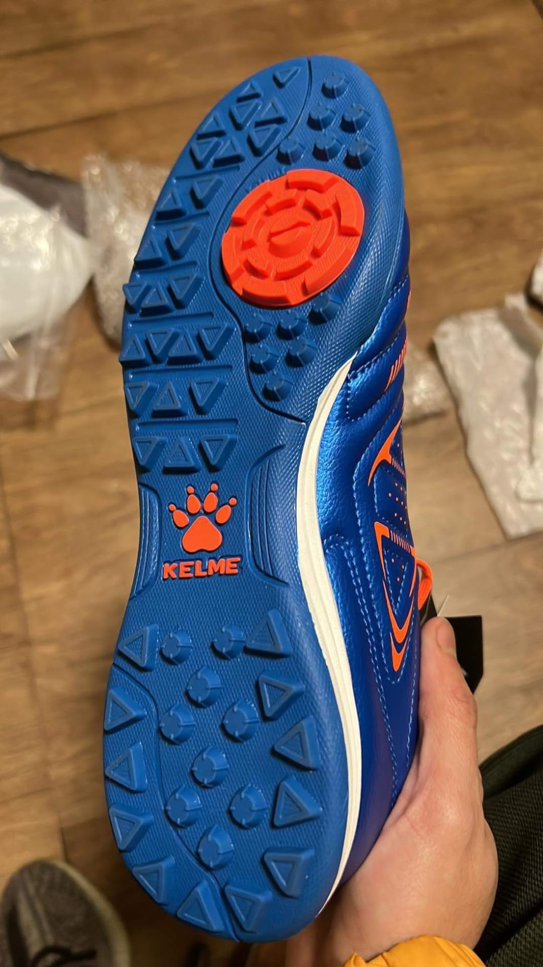 KELME cleats in action on indoor turf surface showing traction and movement