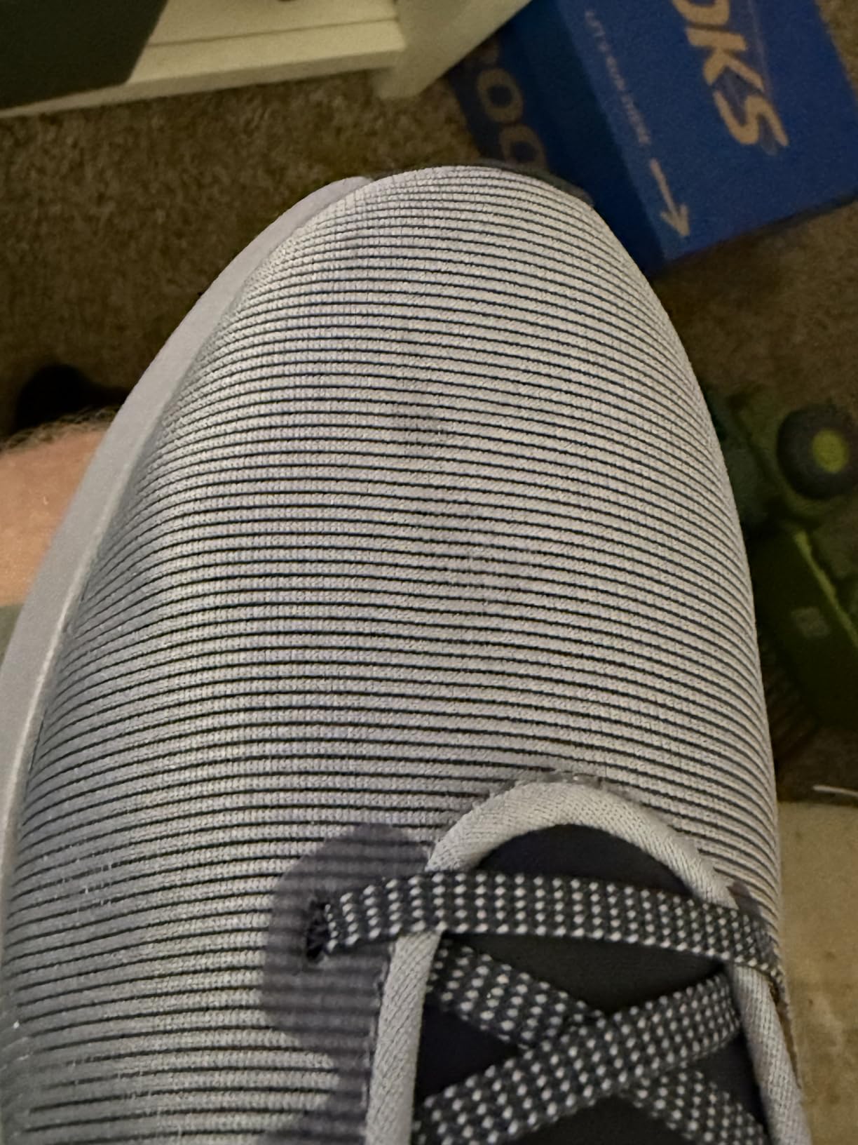 Nike Downshifter 12 showing side angle with visible midsole cushioning and rubber outsole pattern