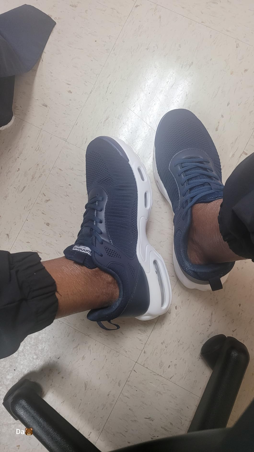 Black men's fashion sneakers showing mesh upper and air cushioning sole design