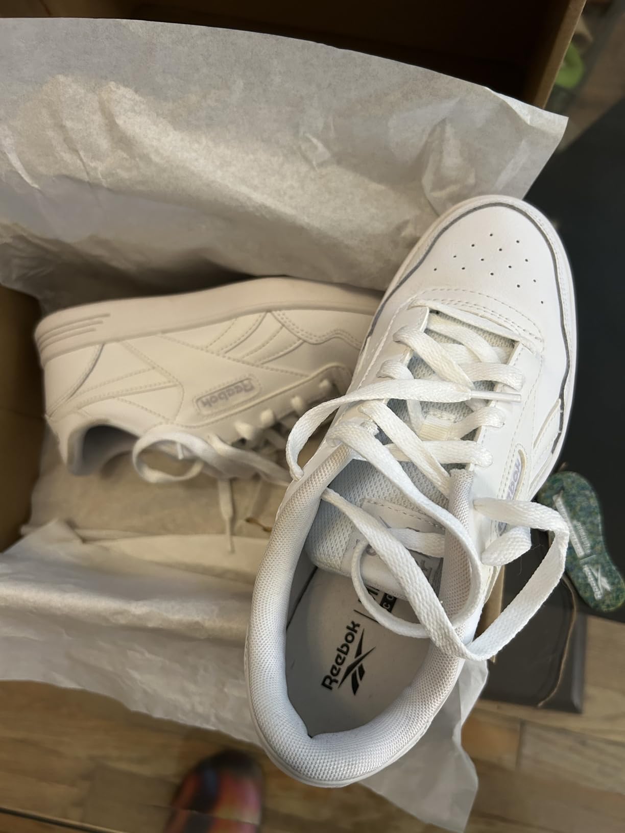 Reebok Court Advance side profile view showing classic tennis shoe silhouette and rubber outsole pattern