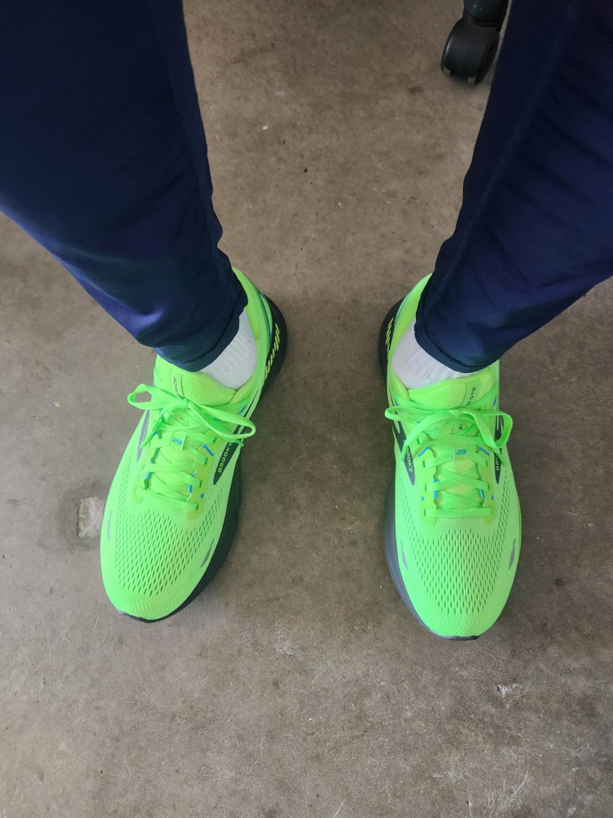 Brooks Men's Adrenaline GTS 23 running shoes in bright green colorway showing side profile and GuideRails technology