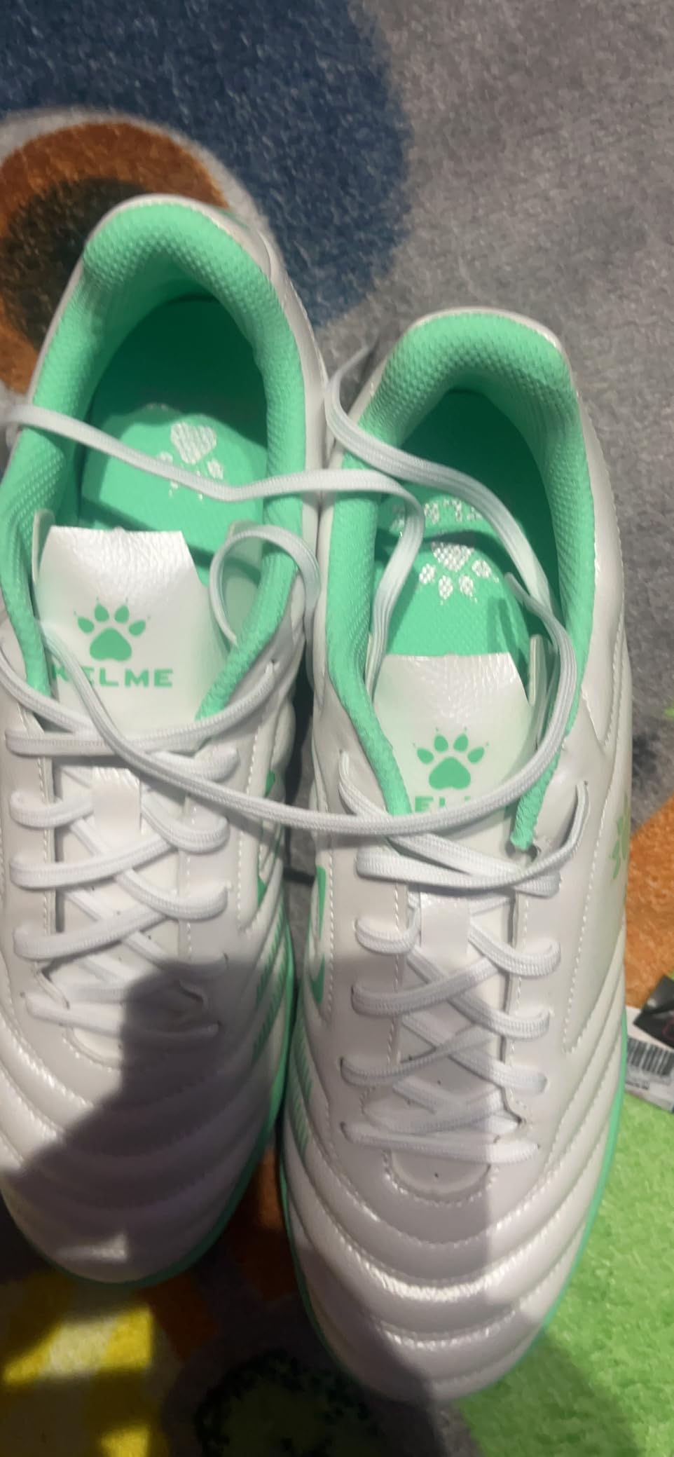 Final product shot of KELME turf soccer cleats showing overall design and value proposition