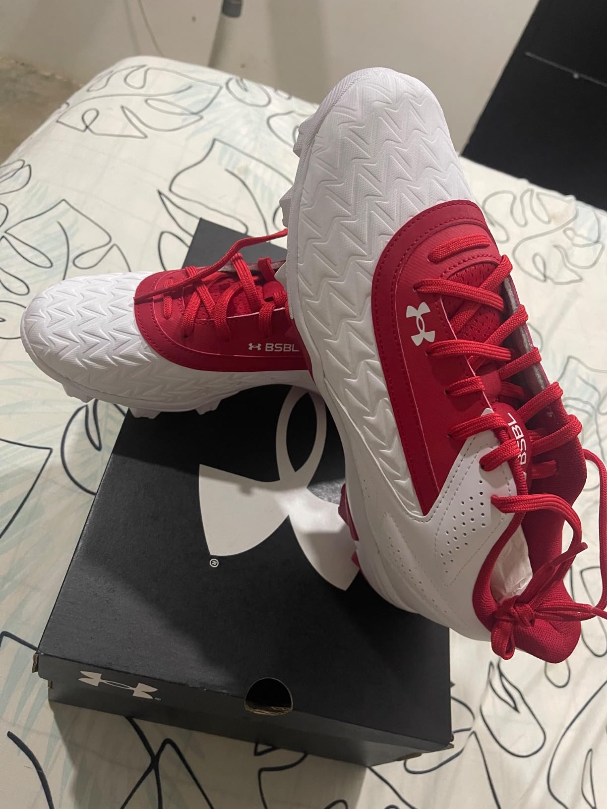 Under Armour baseball cleats showing wear patterns after multiple games