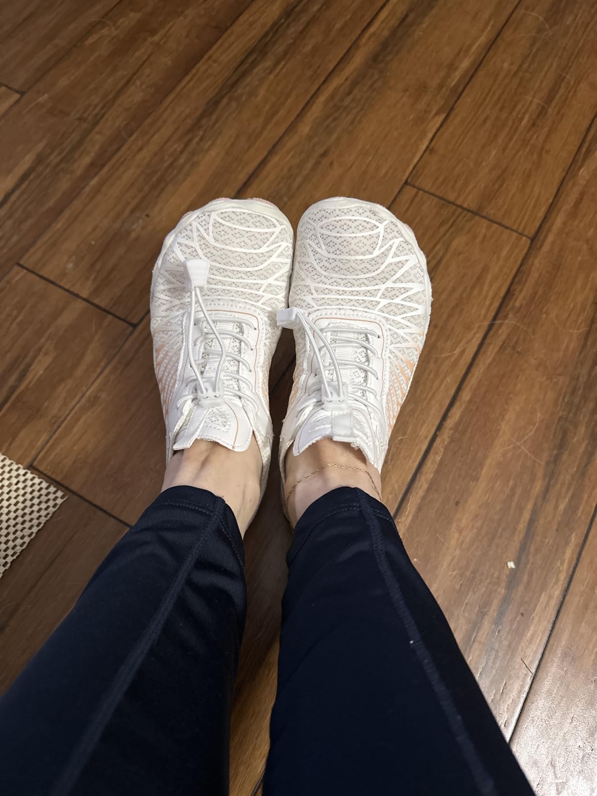 Barefoot shoes showing flexible sole and drainage hole design for water activities