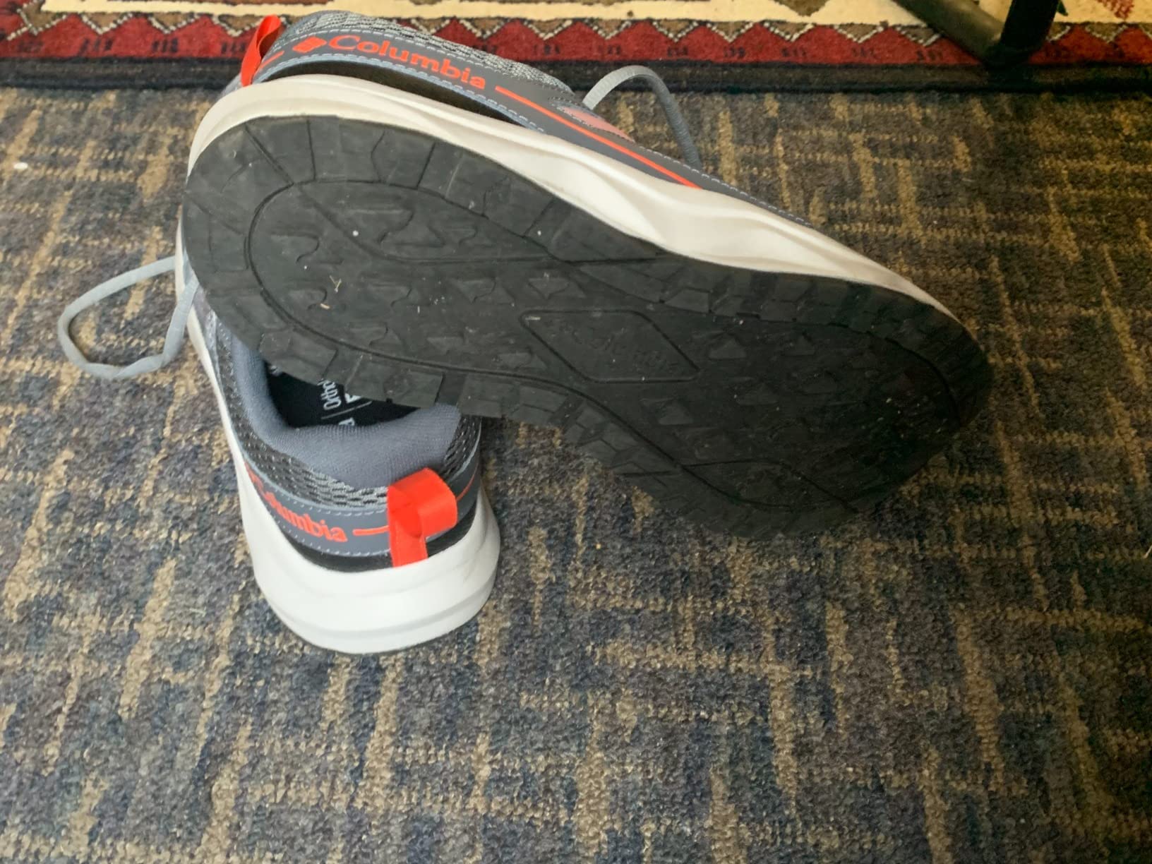 Columbia Men's Plateau hiking shoe showing gray and orange colorway with breathable mesh upper