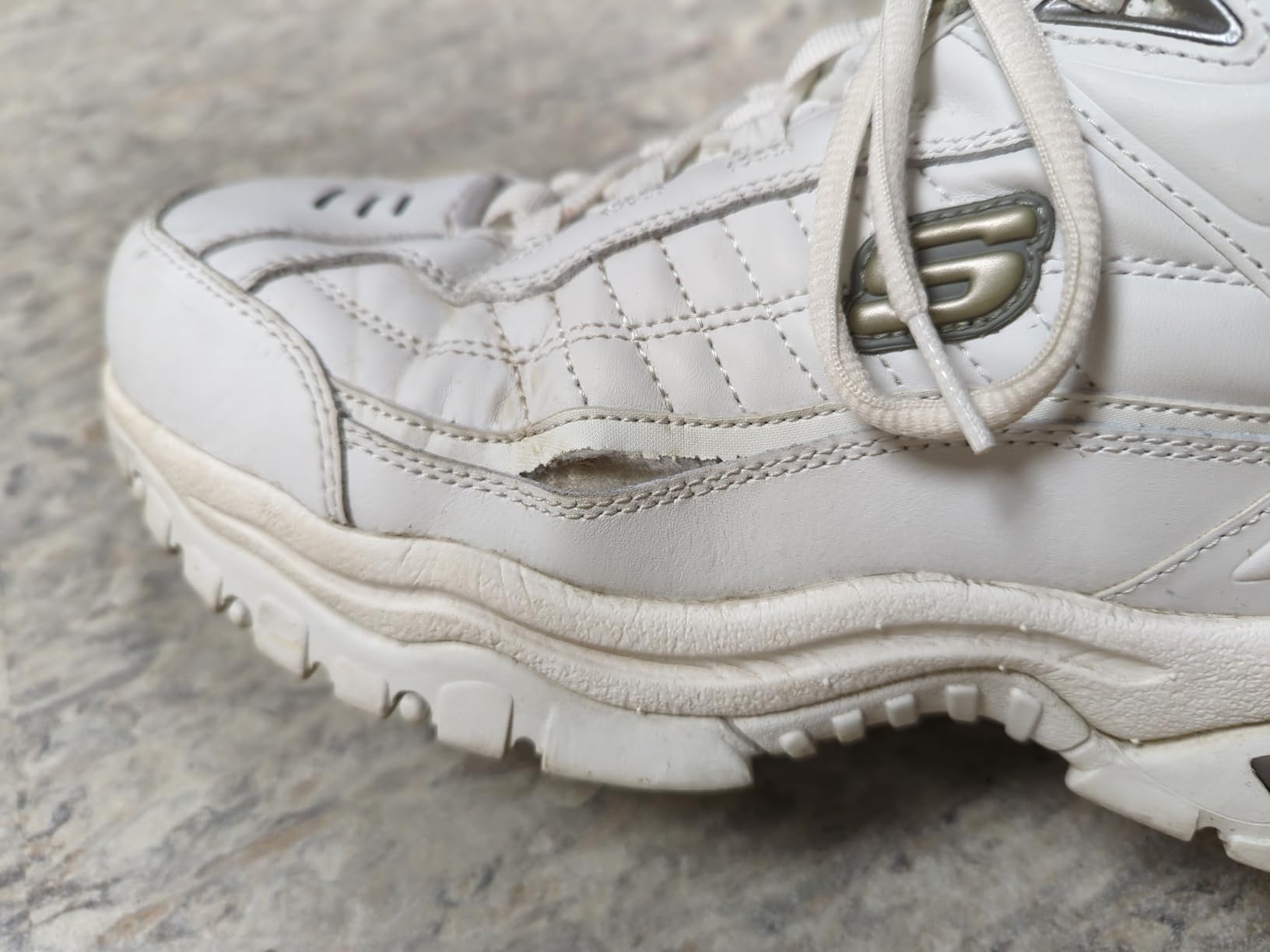 Skechers Energy Afterburn showing typical wear pattern and seam separation after extended use