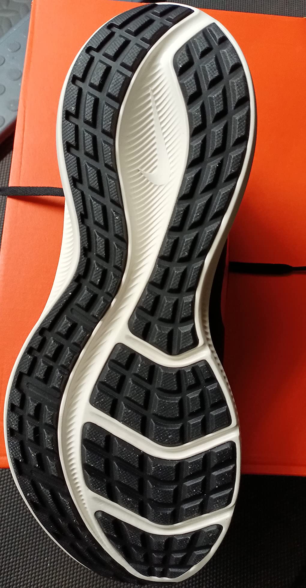 Nike Men's Stroke Running Shoe outsole pattern showing rubber tread design for various surfaces