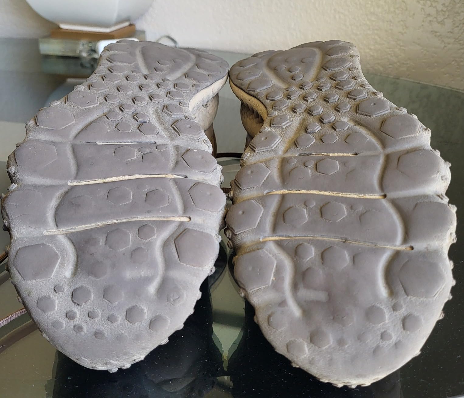 Under Armour trail running shoe in action showing grip performance on rocky terrain and trail conditions