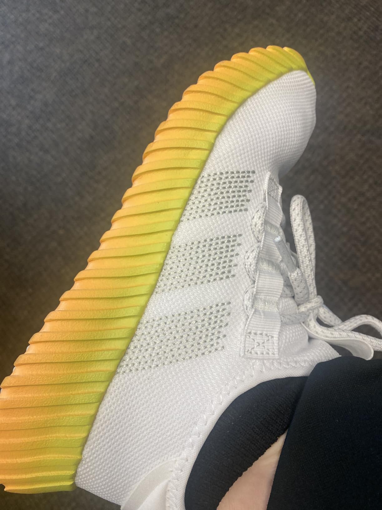 Close-up view of Adidas Kaptir Flow mesh upper construction and lacing system