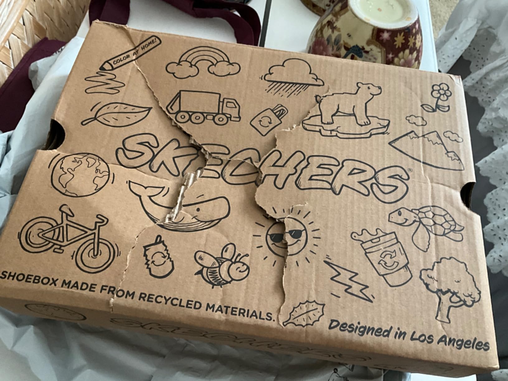 The Skechers kids sneakers shown in their original packaging box.