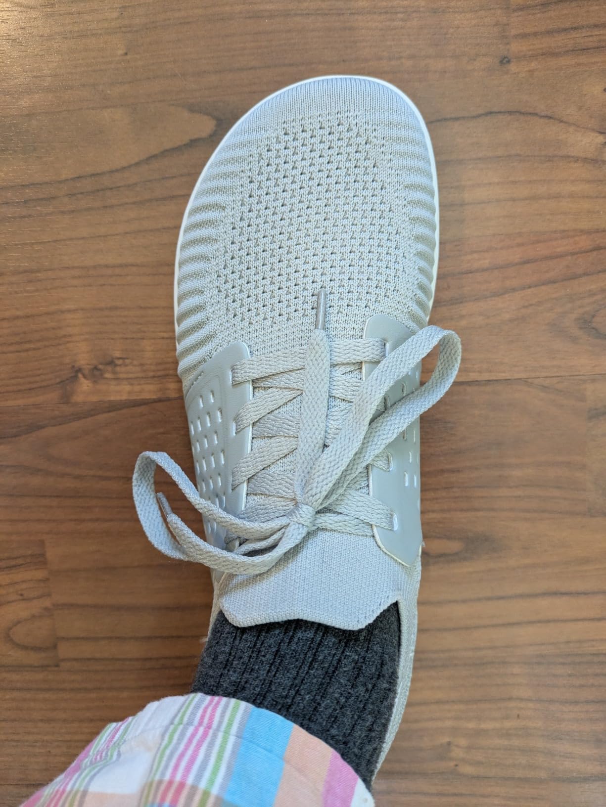 Close-up view of WHITIN barefoot shoes showing knit upper construction and lacing system