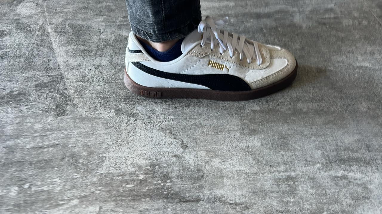 PUMA Club II Era on foot showing real-world styling with jeans