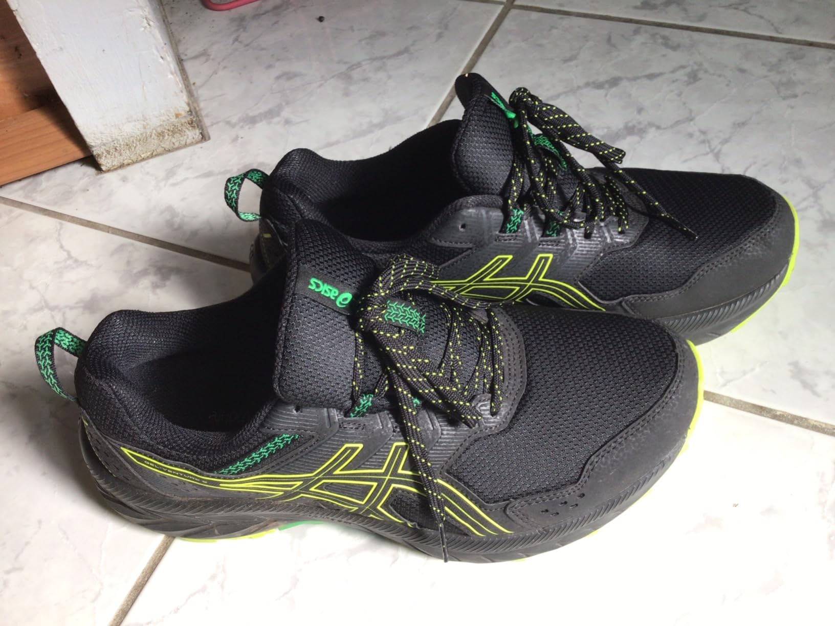 ASICS Gel-Venture 9 in black lime green colorway showing style and fit on feet