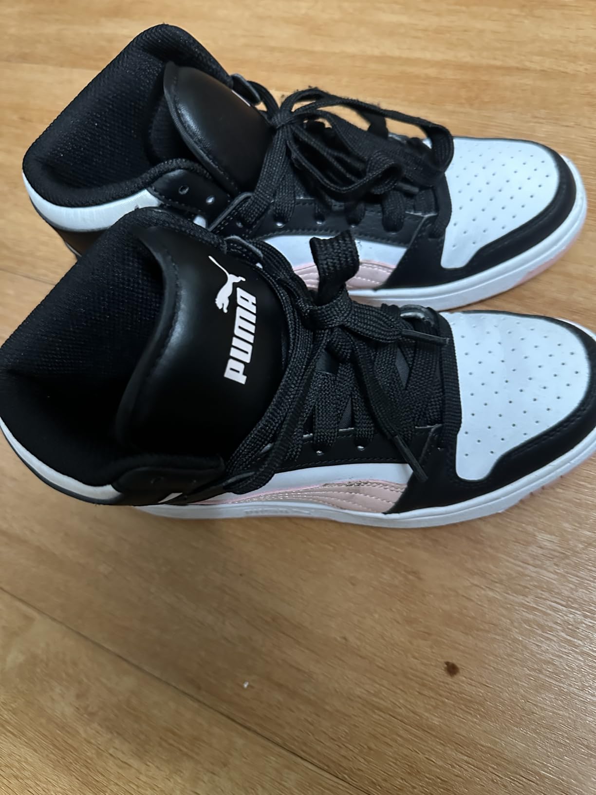 PUMA Rebound Layup Mid detail shot showing synthetic leather upper and padded collar