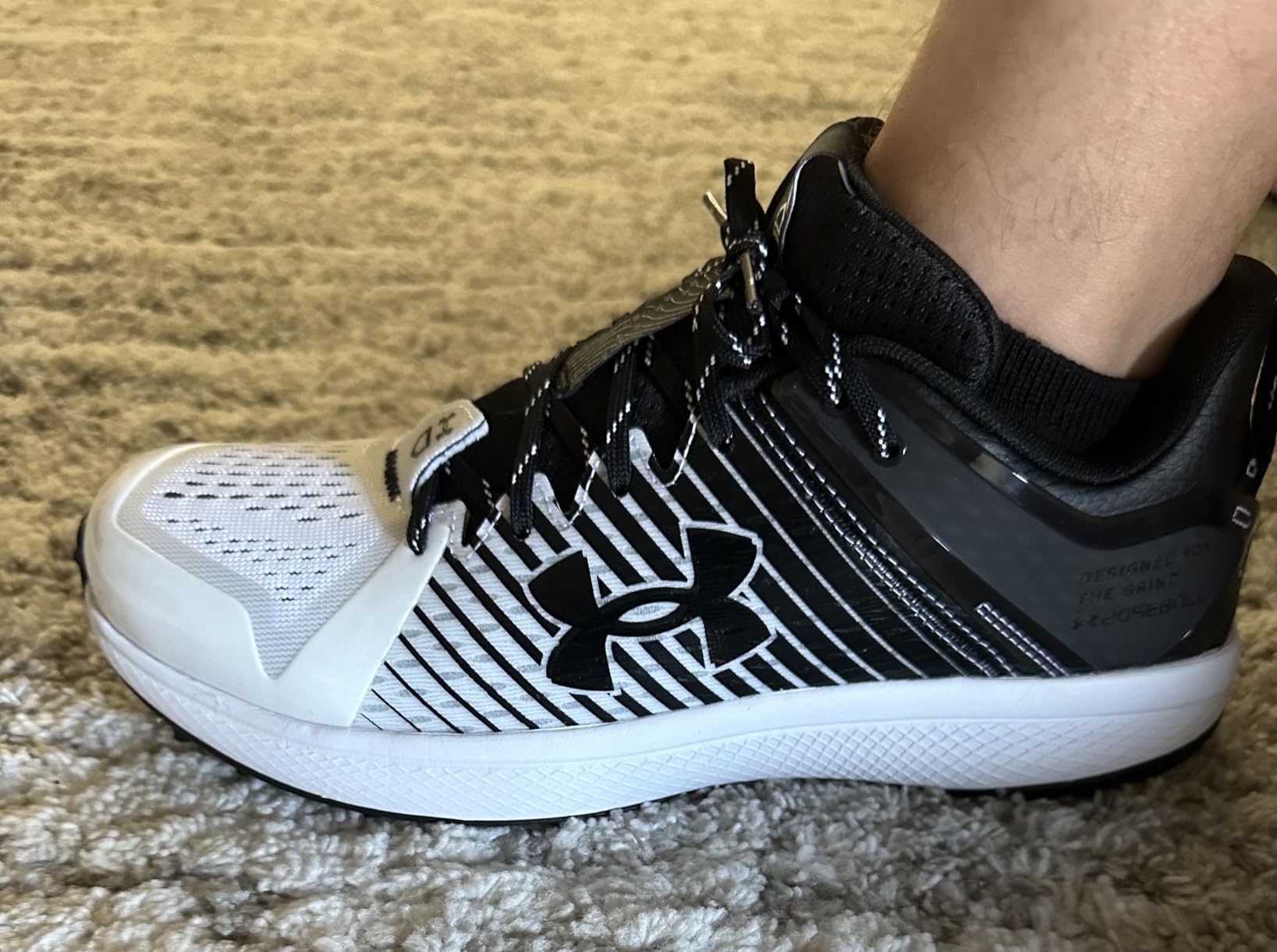 Close-up view of Under Armour Yard Low showing TPU cage and toe drag protection features