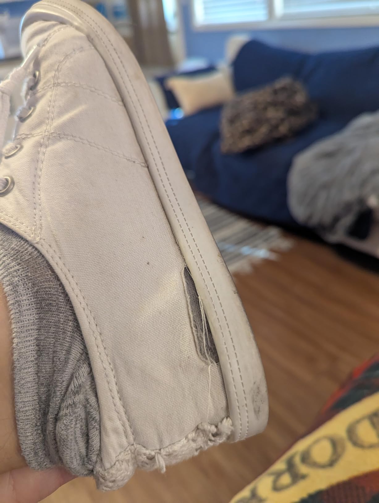 Canvas sneakers showing wear patterns after several weeks of regular use